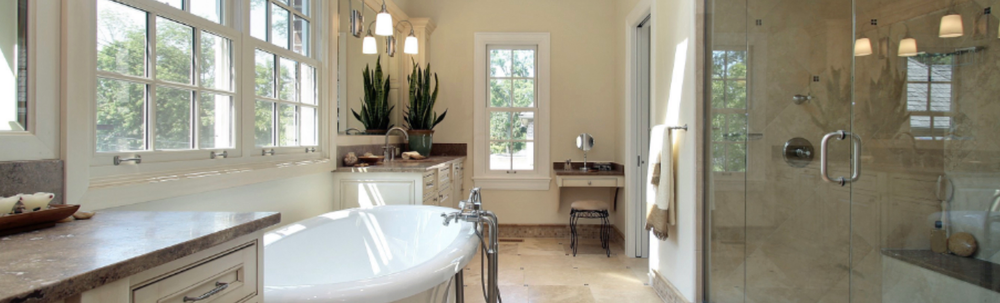 A bathroom with a tub , sink , and shower.