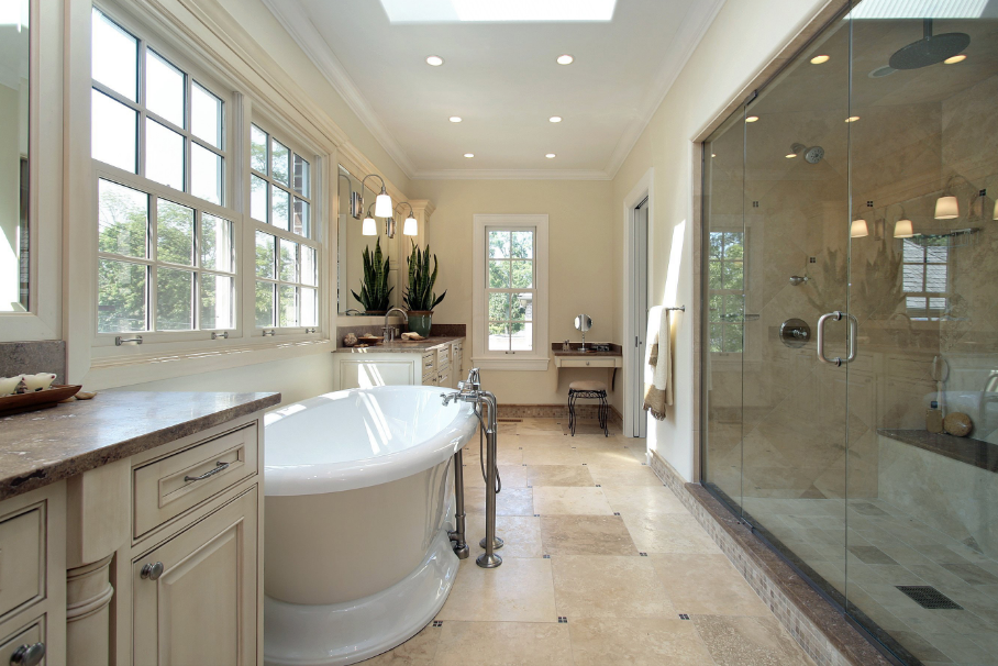 A bathroom with a tub and a walk in shower.