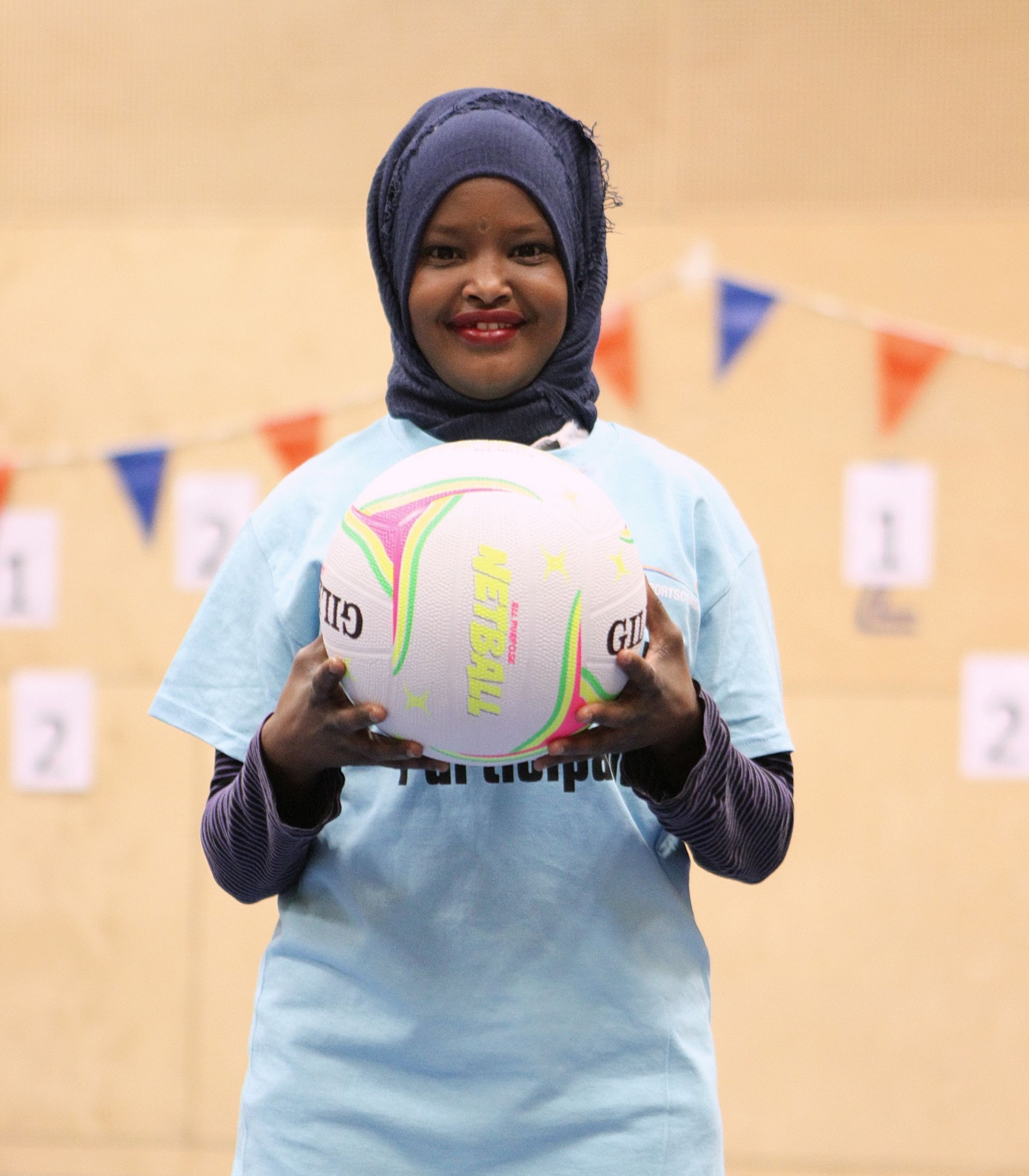 A group of women are putting their hands together in a huddle.
