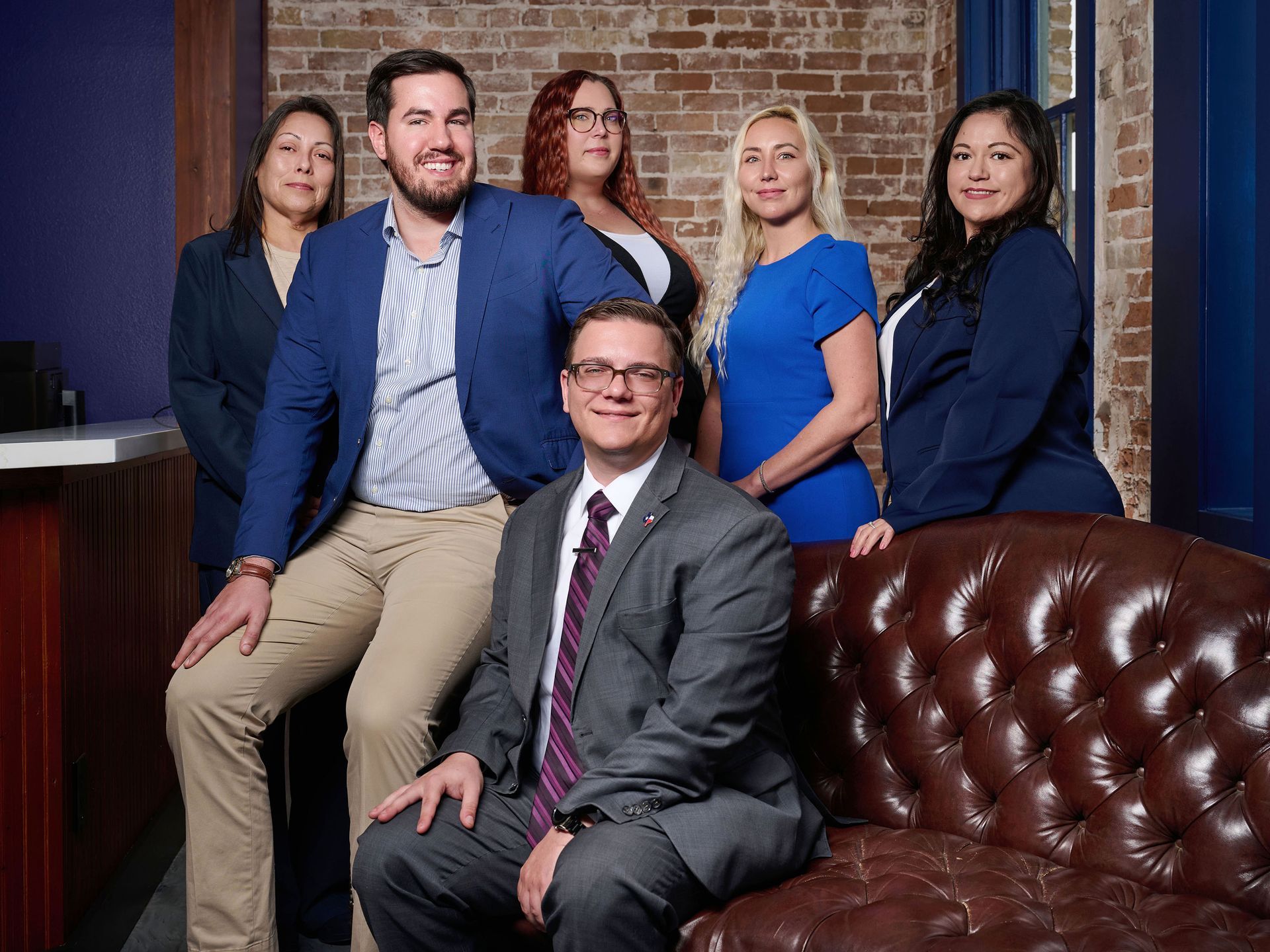A group of people are posing for a picture in front of a house.
