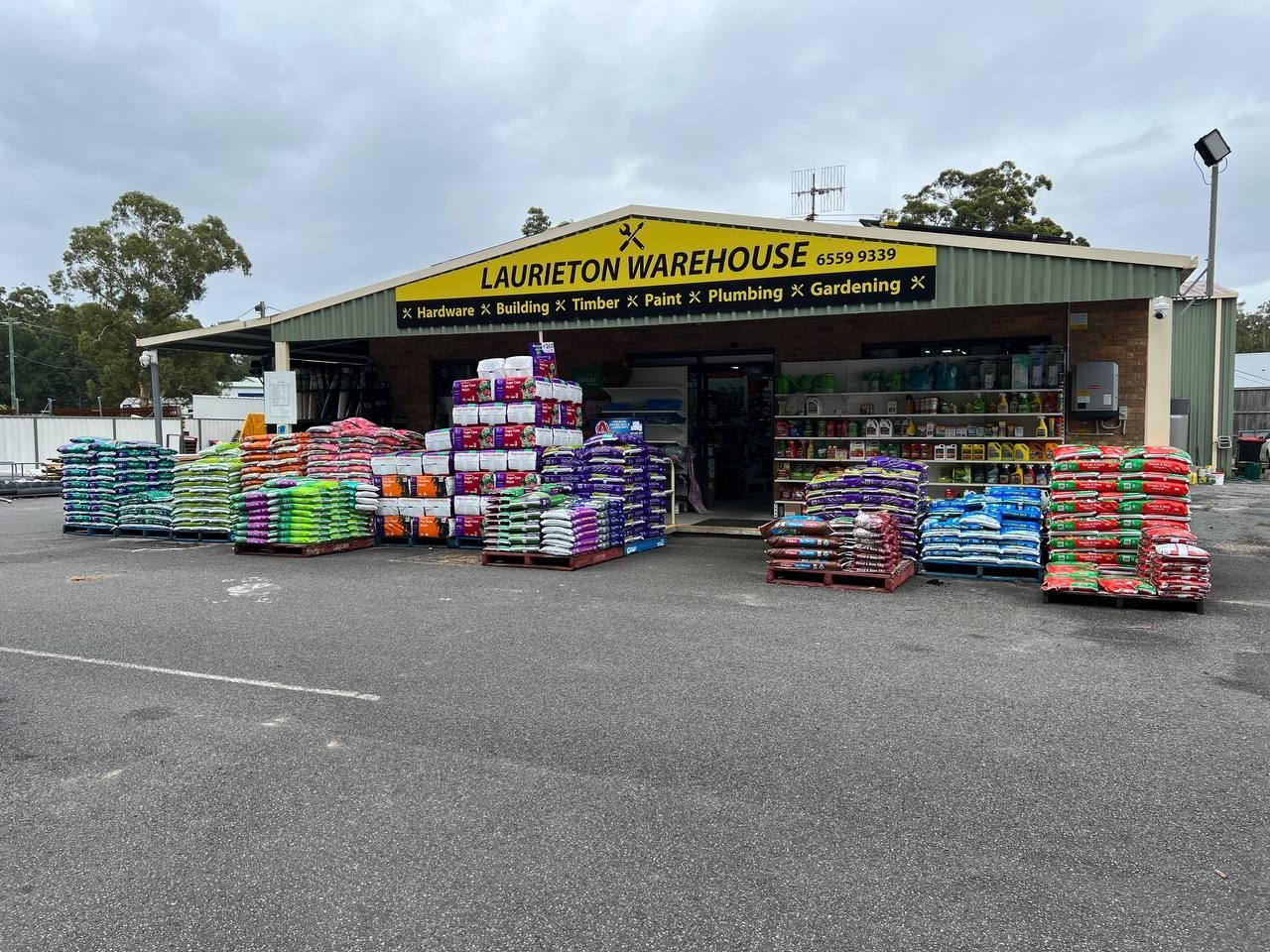 A Variety Of Gardening Tools Are Displayed In A Store — Laurieton Warehouse in Laurieton, NSW