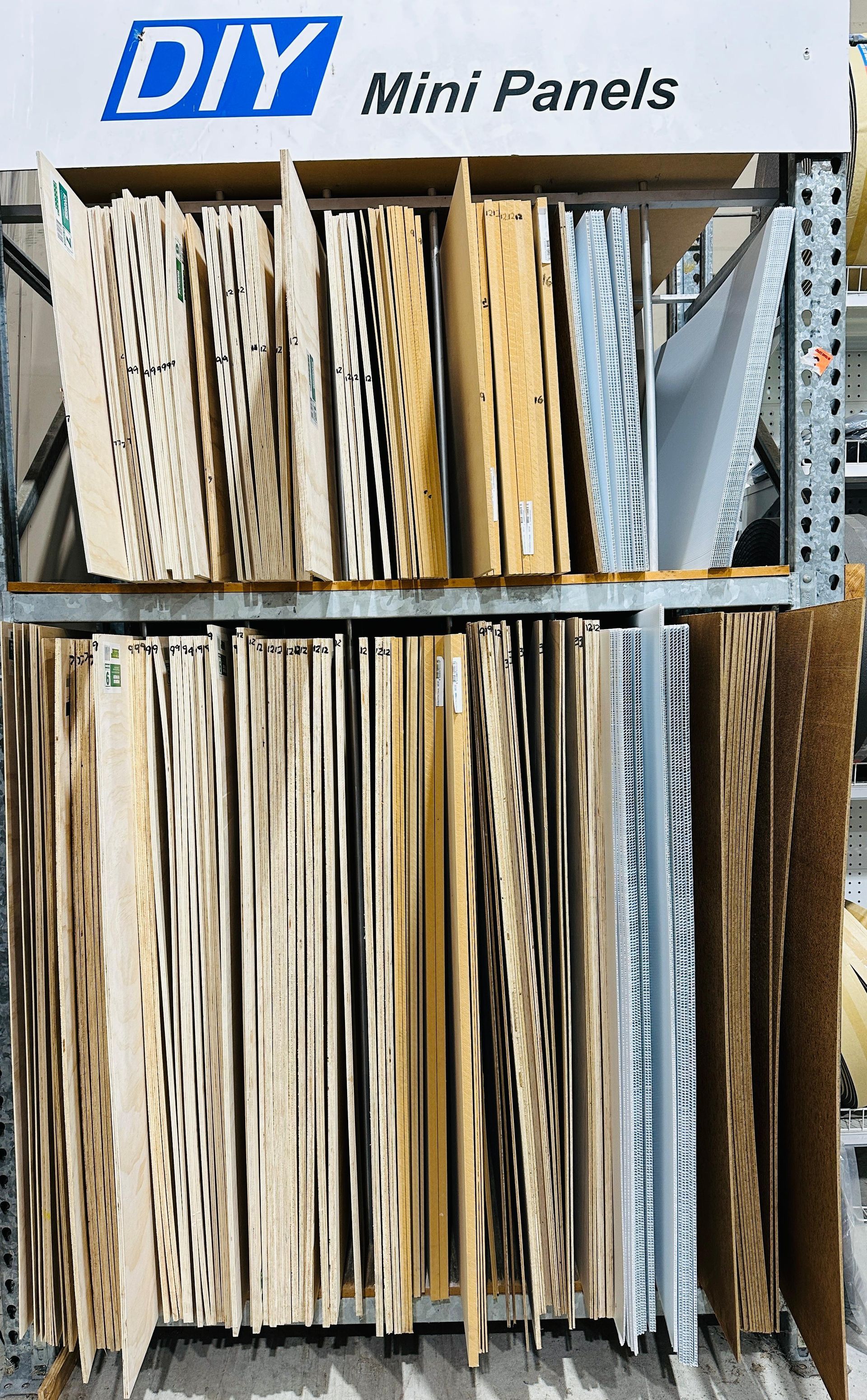 Three Buckets Of Paint Are Sitting On A Wooden Pallet In A Store — Laurieton Warehouse in Laurieton, NSW