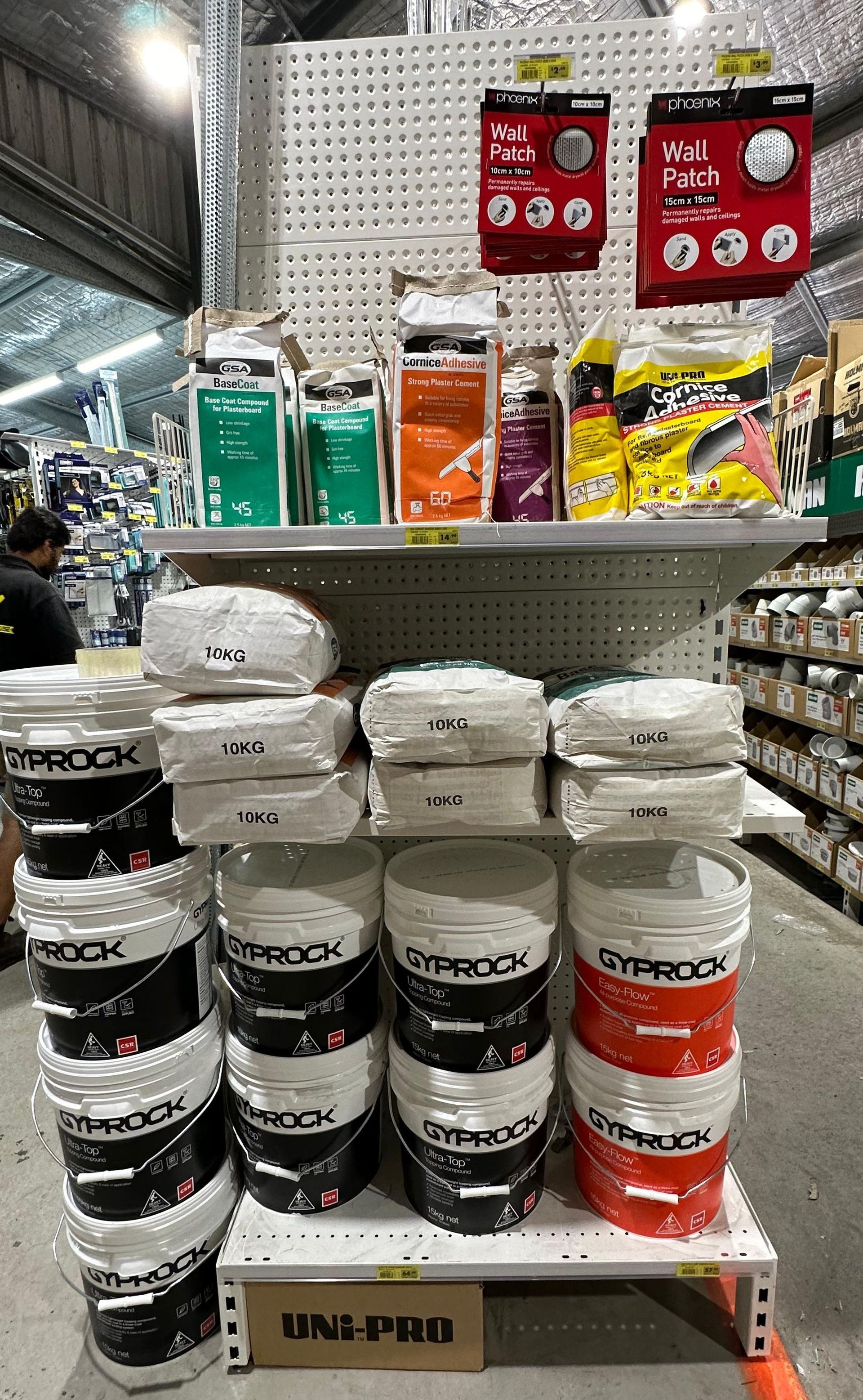 A person is plastering a ceiling with a scraper — Laurieton Warehouse in Laurieton, NSW