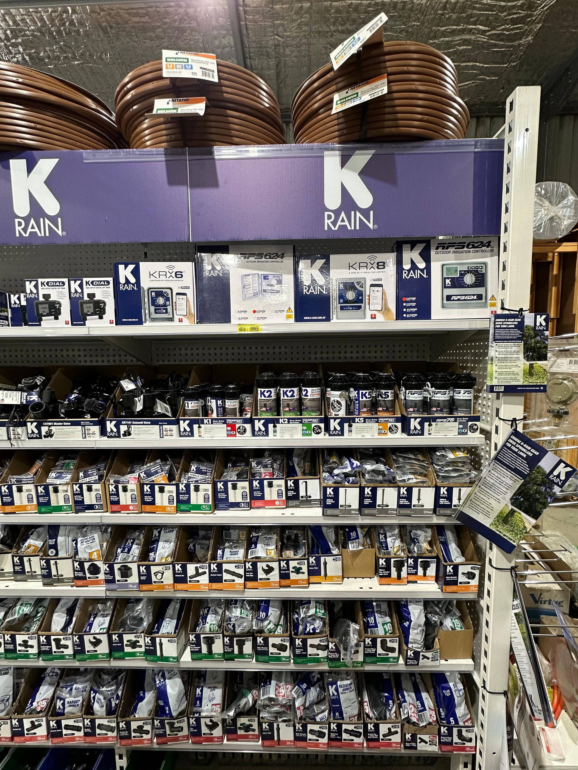 A Bunch Of Bags Of Fertilizer Are Sitting On Pallets In Front Of A Building — Laurieton Warehouse in Laurieton, NSW