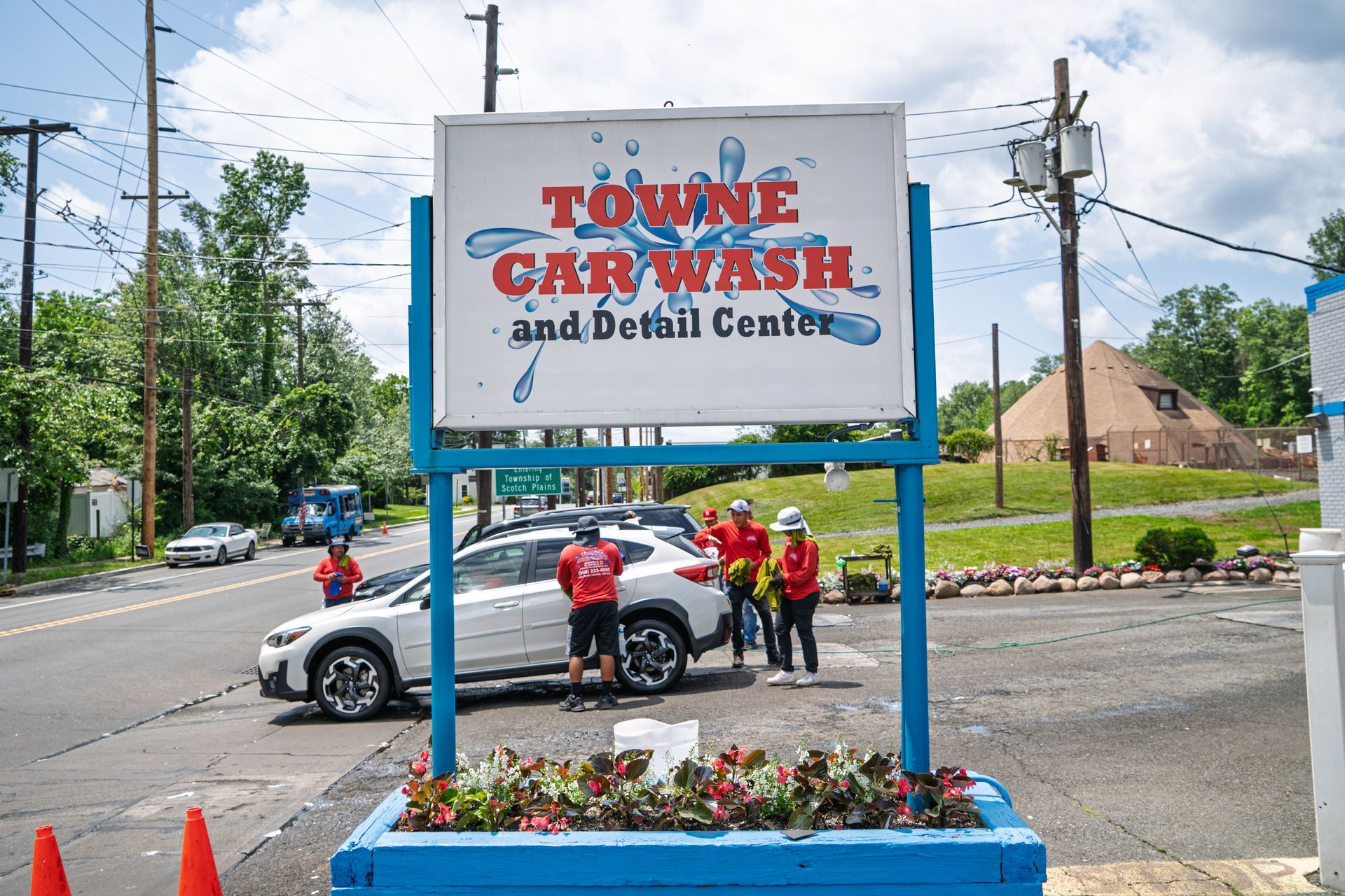 A sign for the toune car wash and detail center