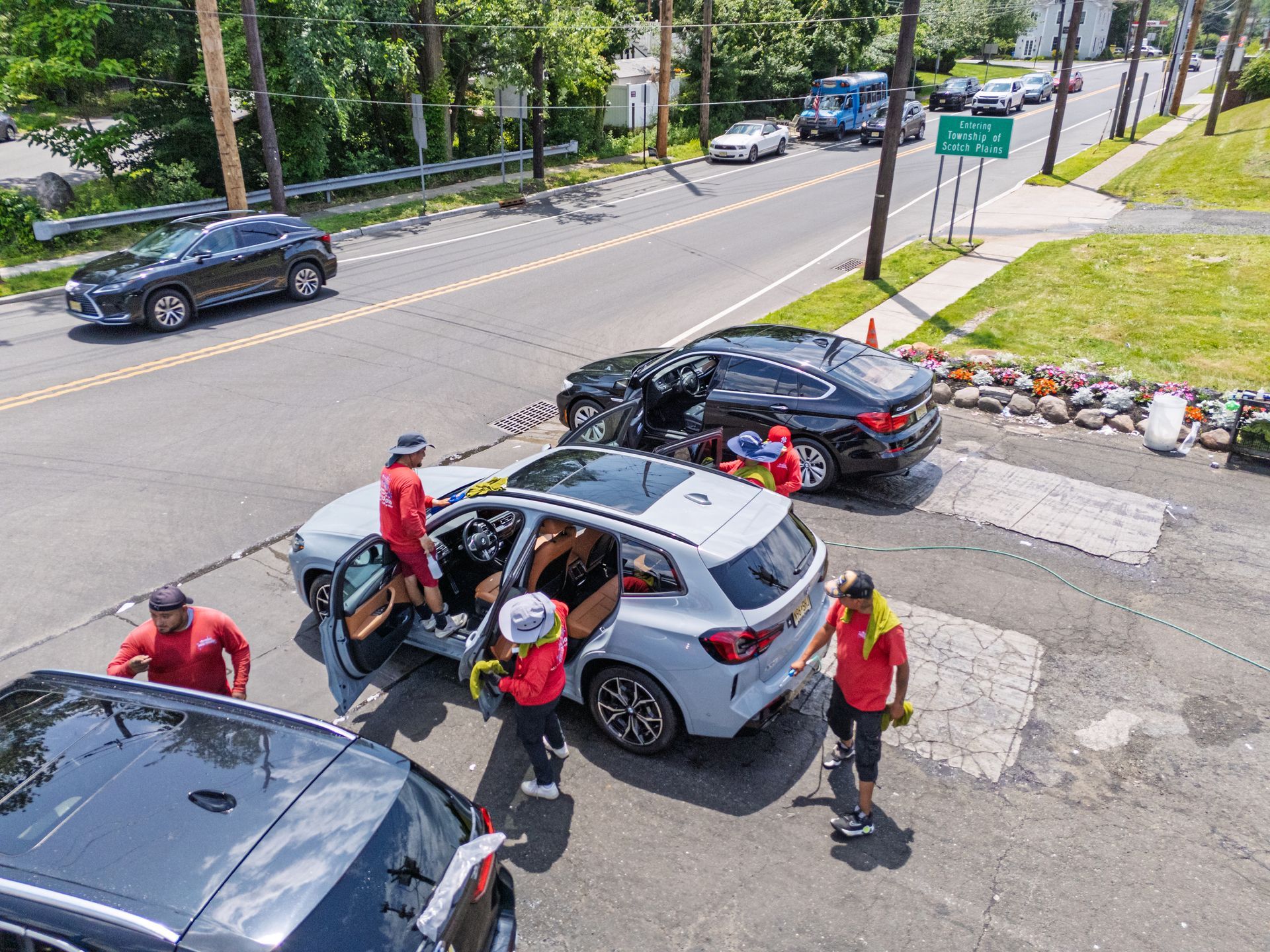 An aerial view of a group of people loading a car in a parking lot.