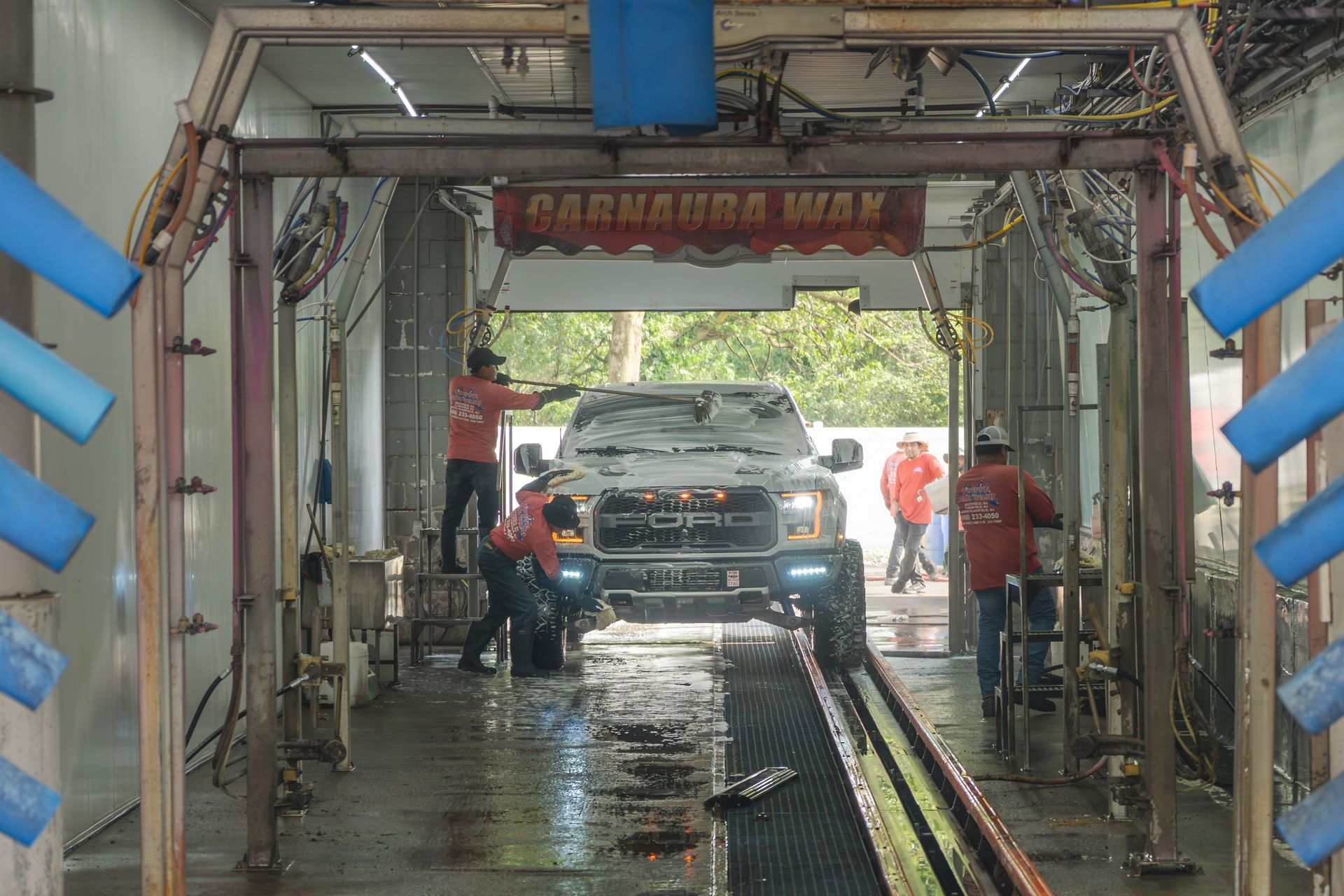 A truck is being washed in a car wash.