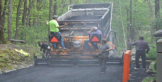 Man Working With Asphalt Paving — Lunenburg, MA — Miller’s Paving, LLC