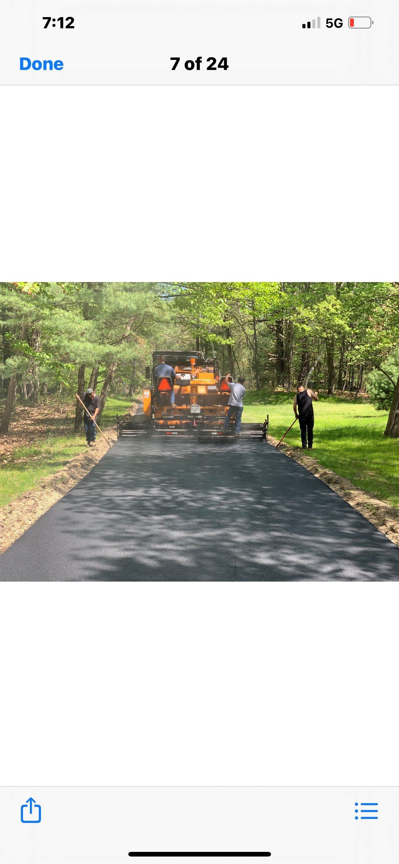 Man Shoveling Asphalt Pavement on Low Deck Asphalt Paver — Lunenburg, MA — Miller’s Paving, LLC