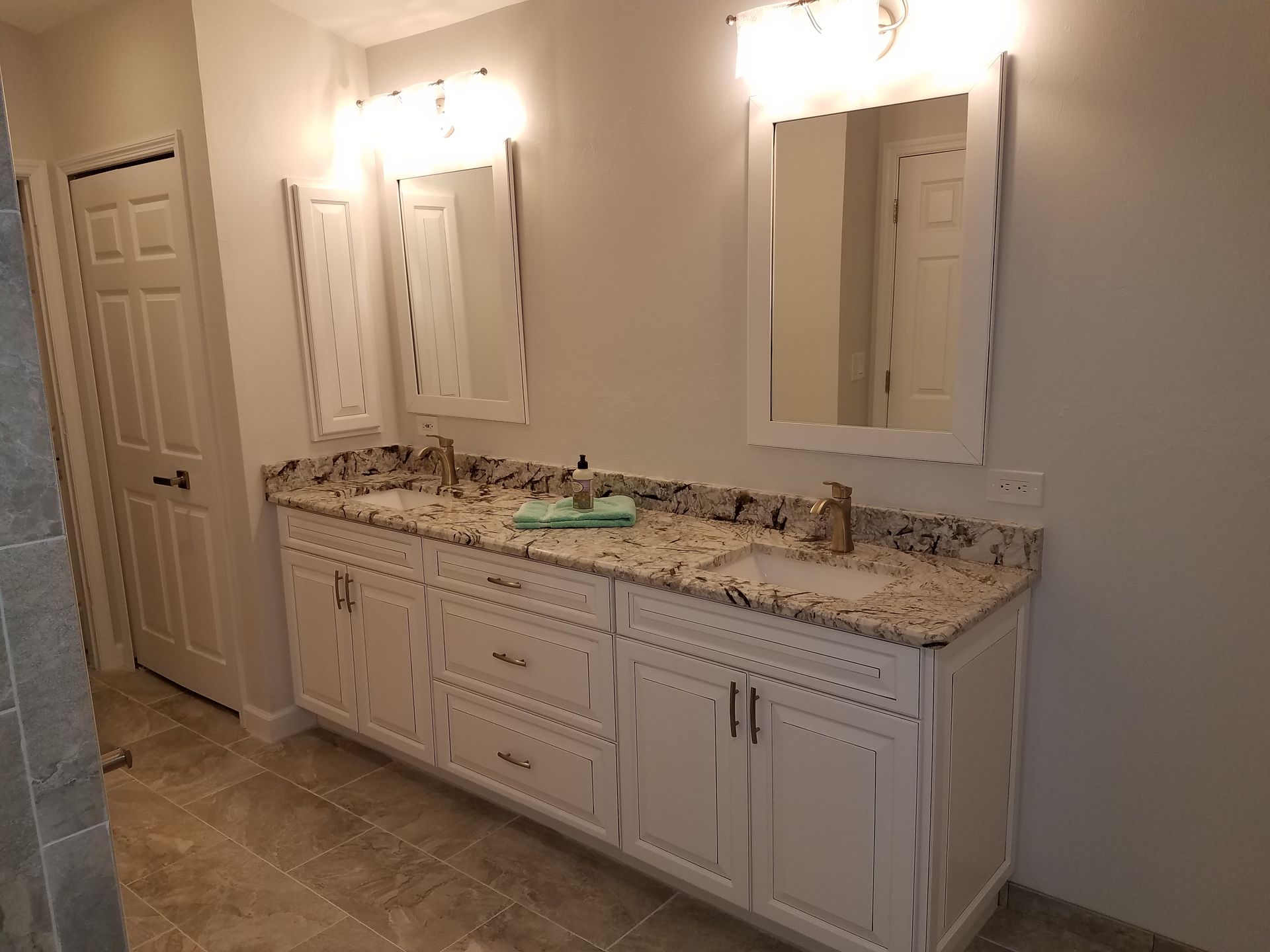 A bathroom with two sinks and two mirrors.