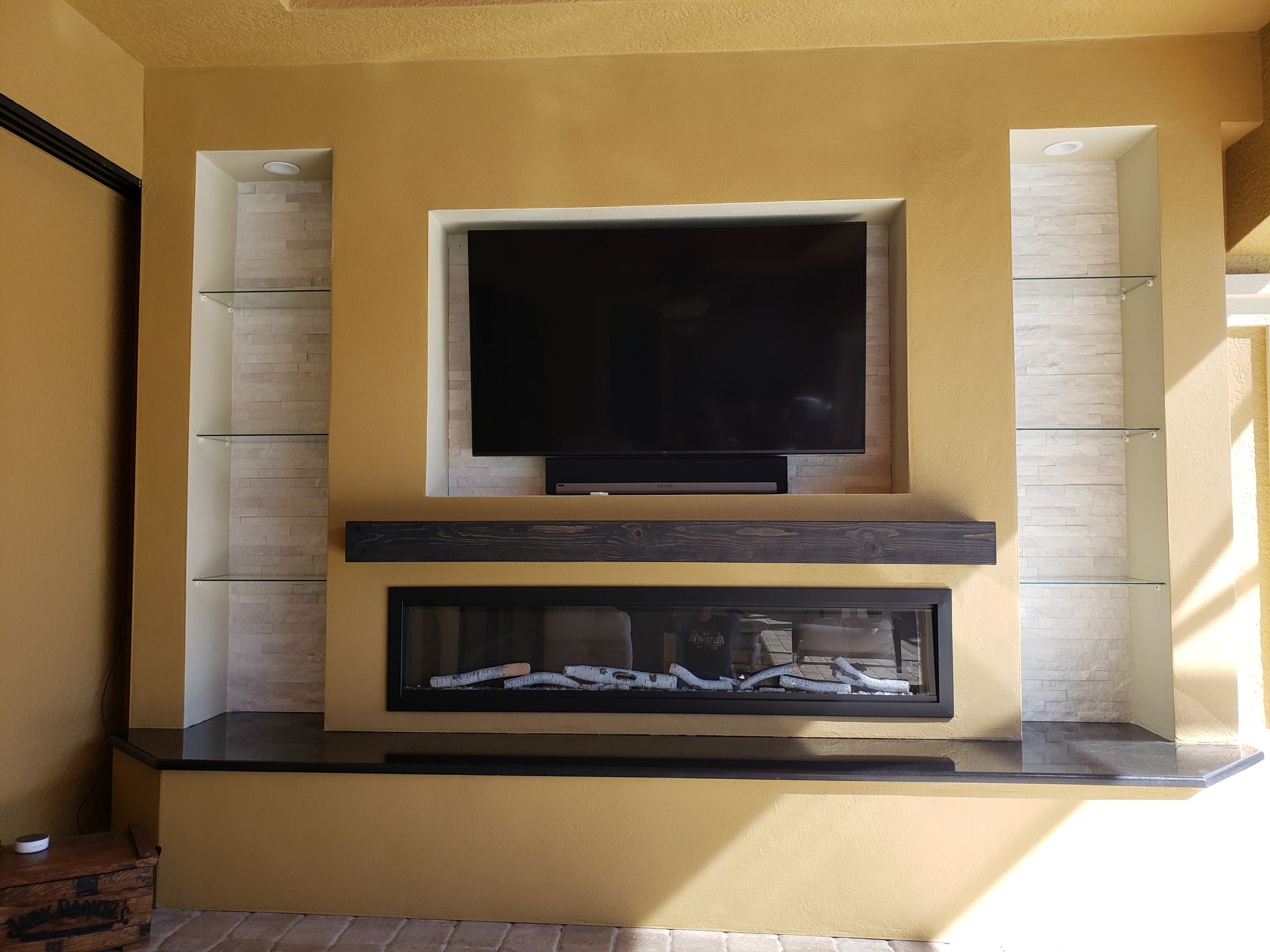 A living room with a fireplace and a flat screen tv