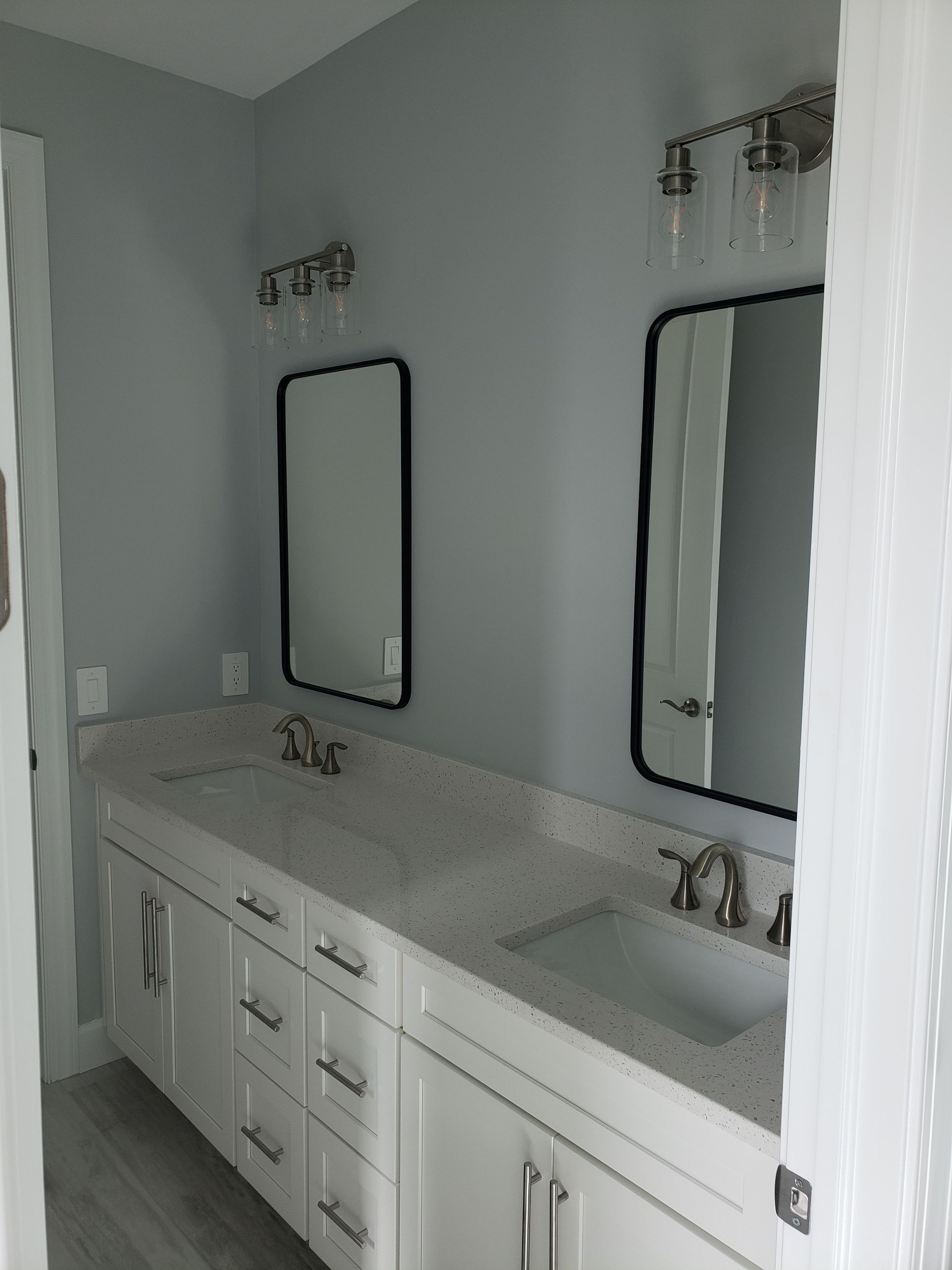 A bathroom with two sinks and two mirrors