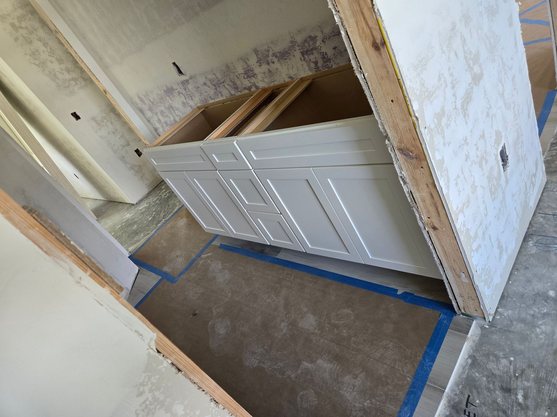 A bathroom vanity is being built in a house.