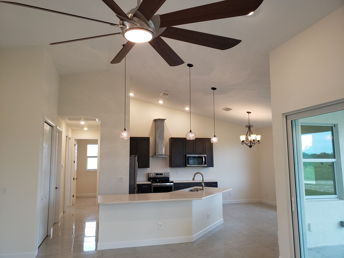 A kitchen with a ceiling fan hanging from the ceiling built by Blue Heron Construction Cape Coral