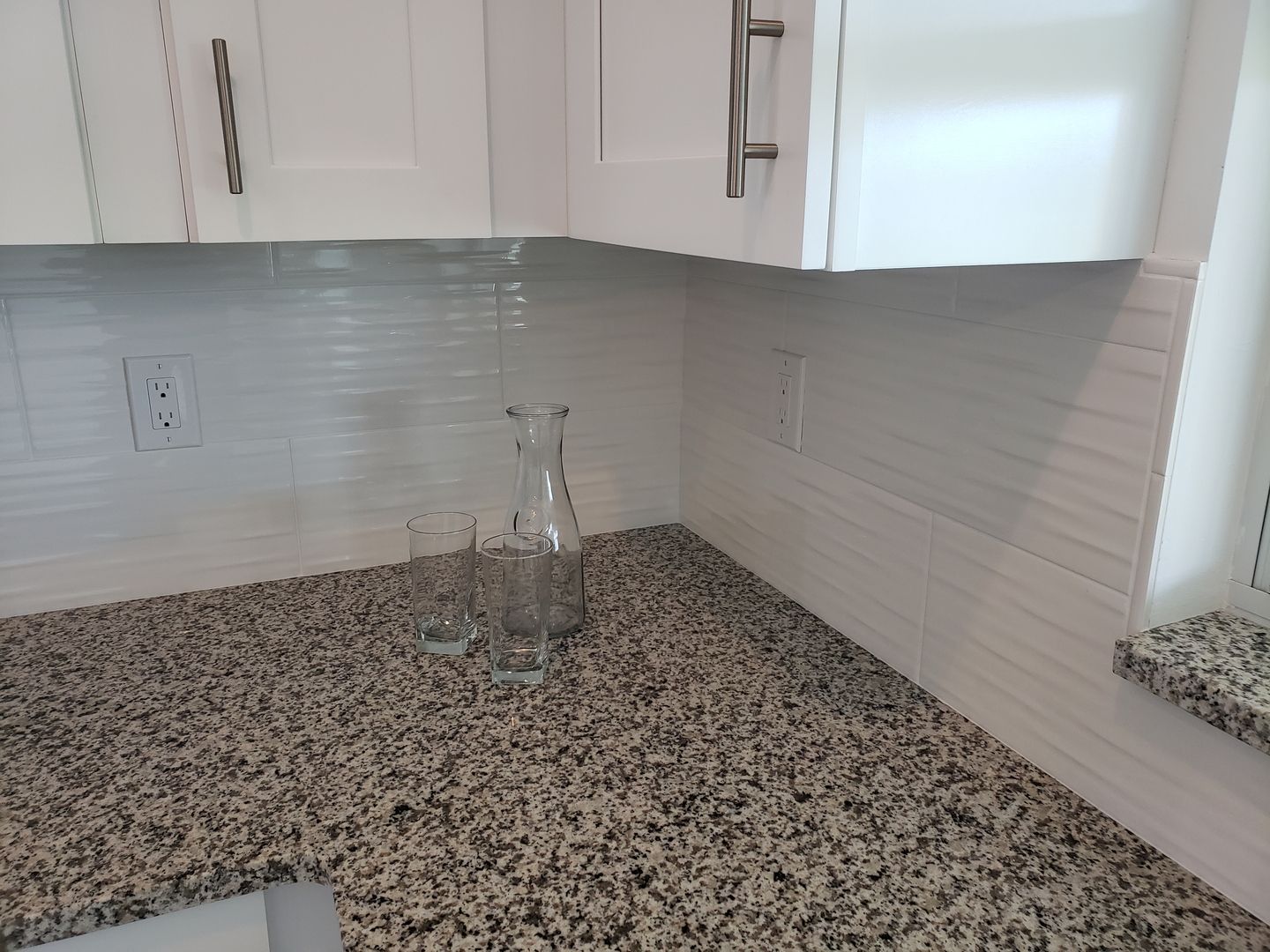 A kitchen counter with a vase and two glasses on it built by Blue Heron Construction Cape Coral