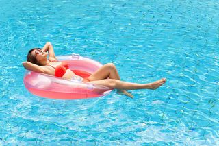 Young Woman Relaxing in Swimming Pool - Swimming Pool in Irving, TX