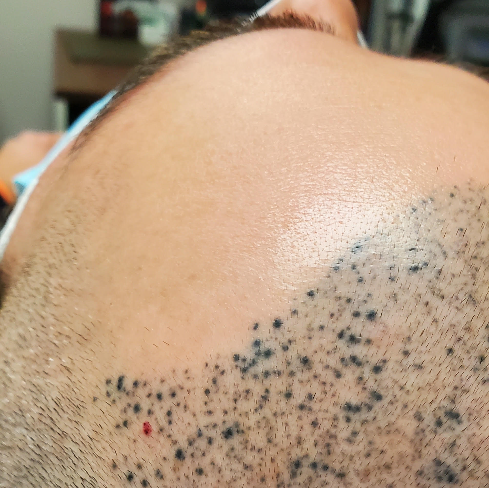 A close up of a person 's head with a tattoo on it