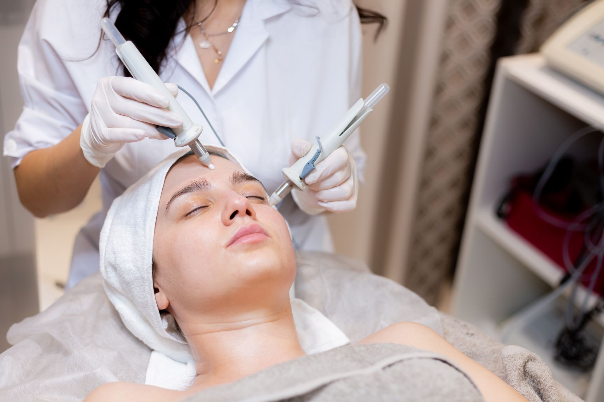 A woman is getting a facial treatment at a beauty salon.