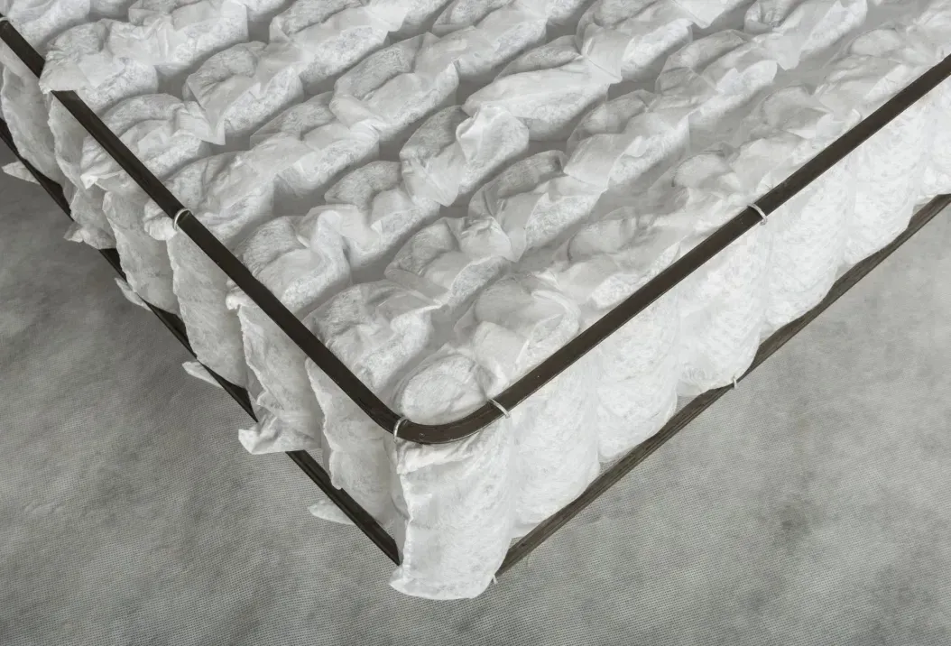 A black and white photo of a mattress on a bed.