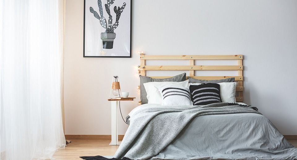 There is a picture of a cactus on the wall above the bed.