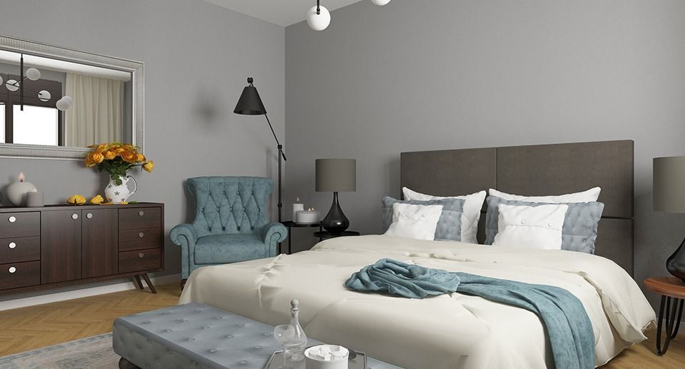 A bedroom with a large bed , chair , dresser and mirror.