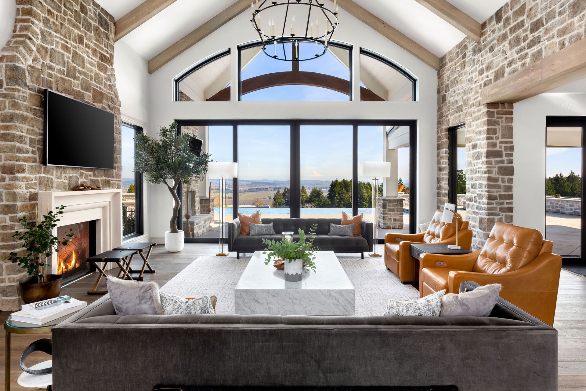 a living room with a couch , chairs , a fireplace and a flat screen tv .