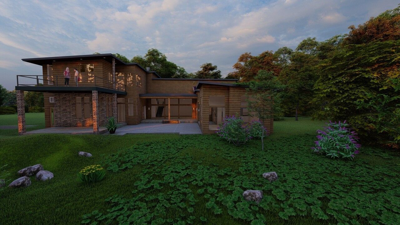 A large house is sitting in the middle of a lush green field surrounded by trees.