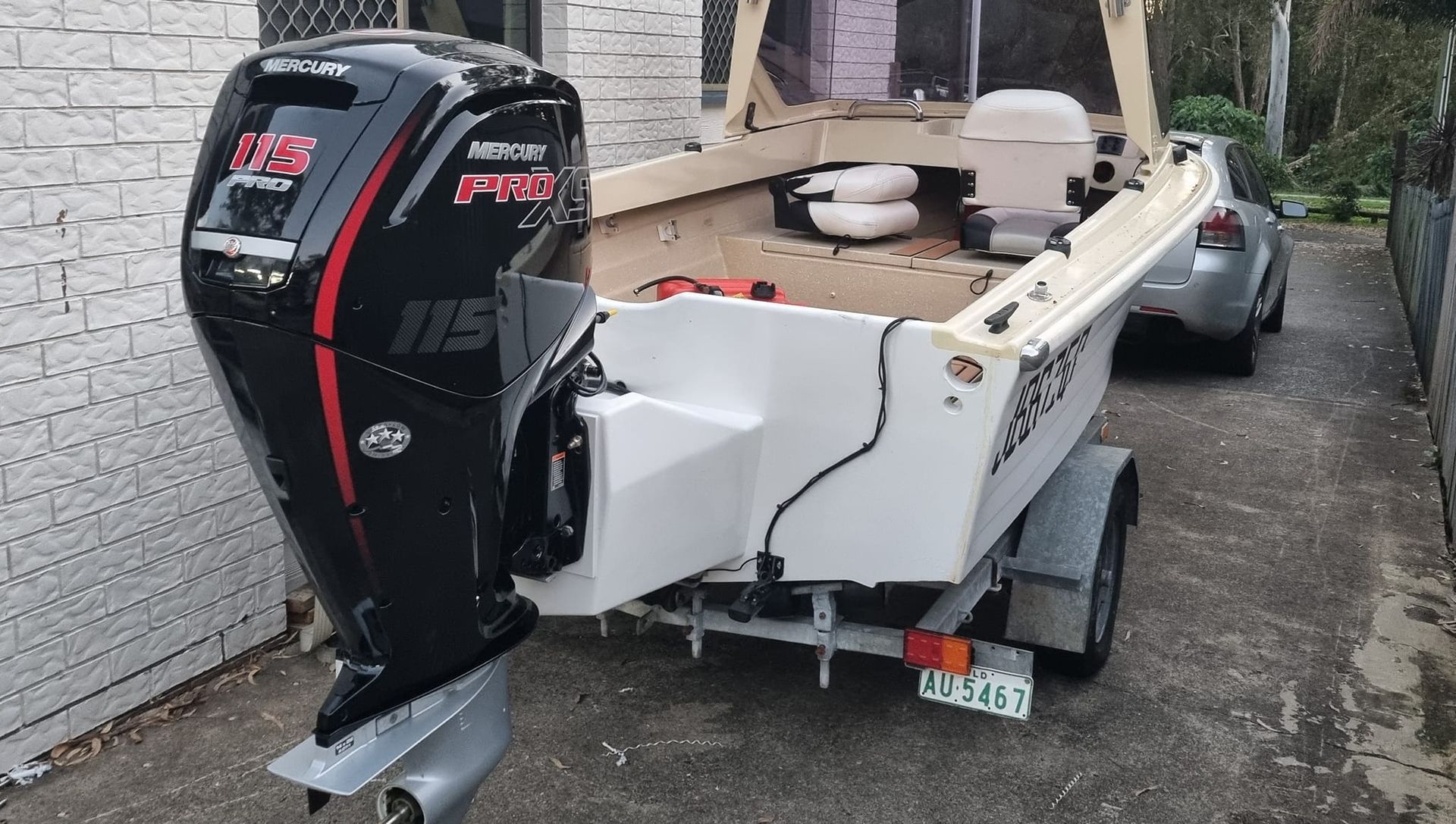 A boat engine is sitting on top of a pile of junk.