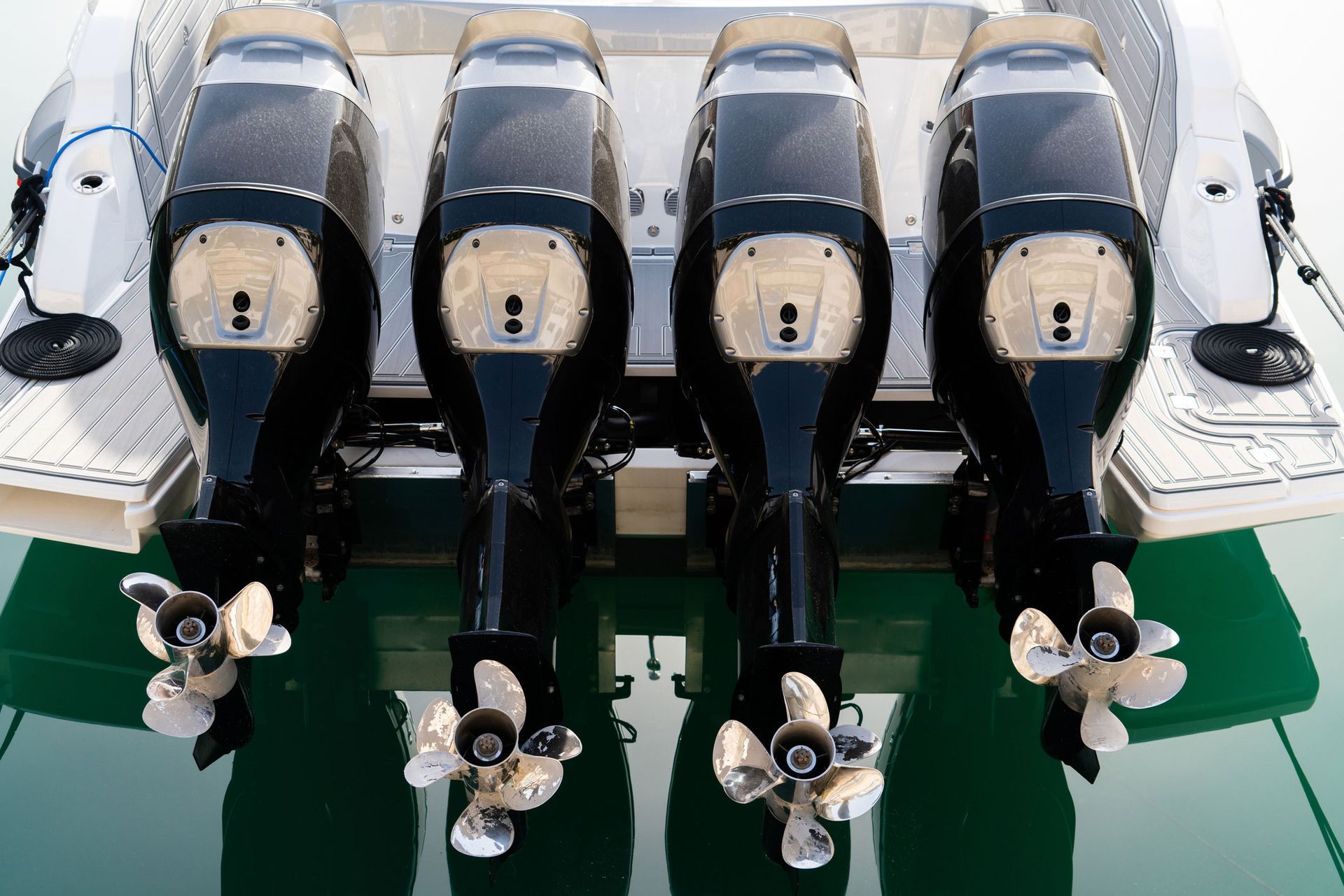 A boat with four outboard motors is sitting in the water.