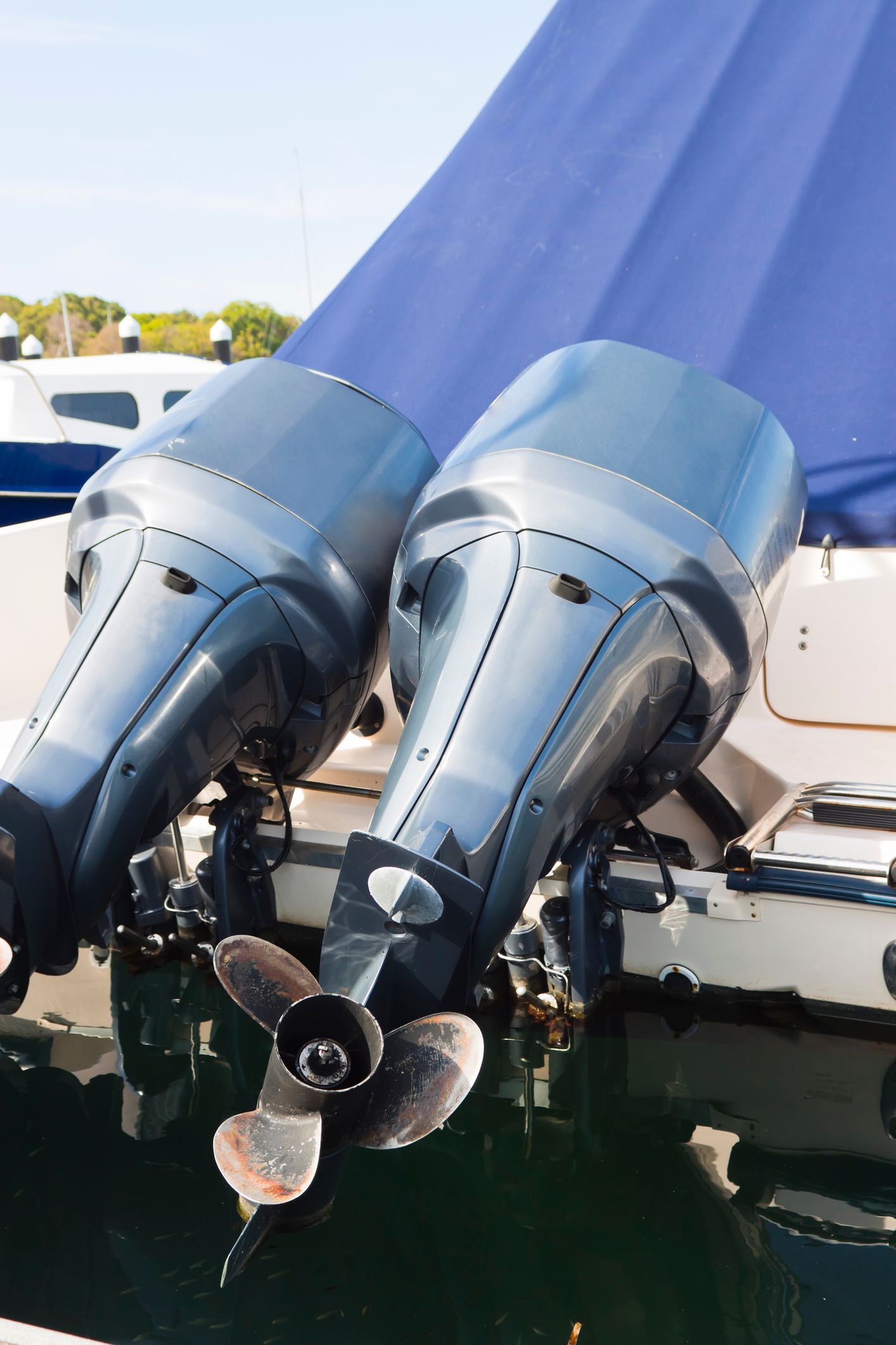 Two outboard motors are attached to the back of a boat.