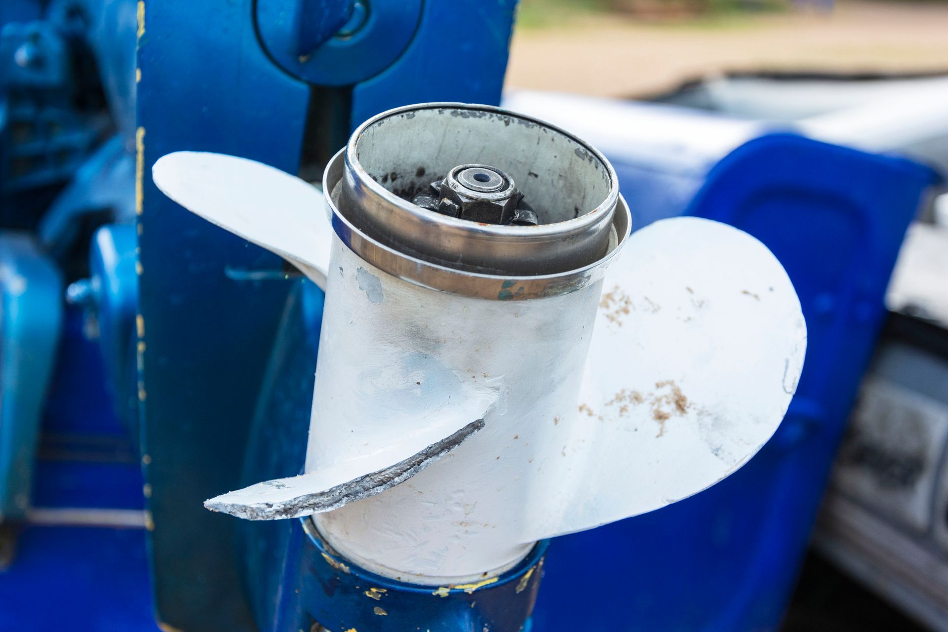 A close up of a propeller on a blue boat