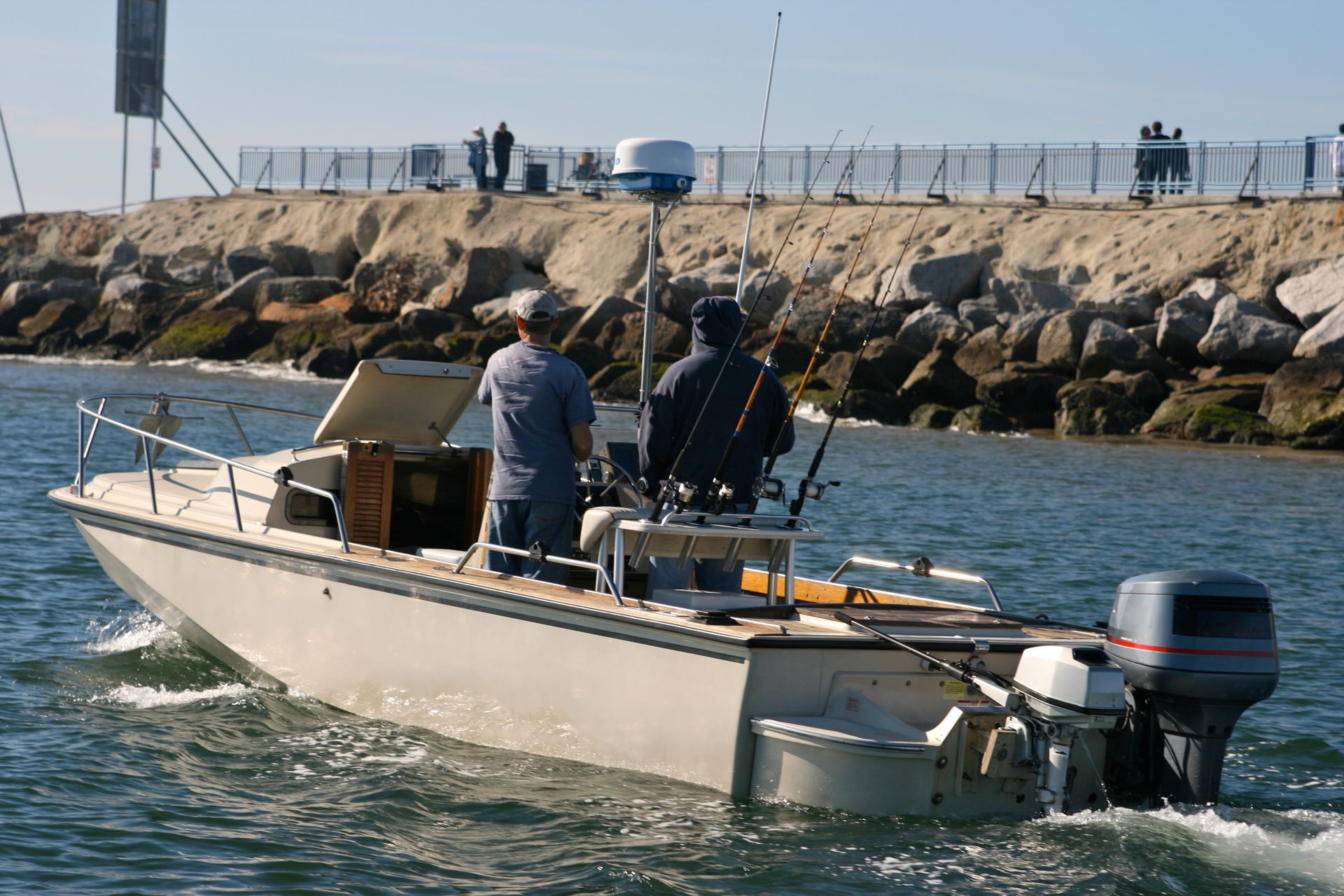 Two men are fishing on a boat in the water