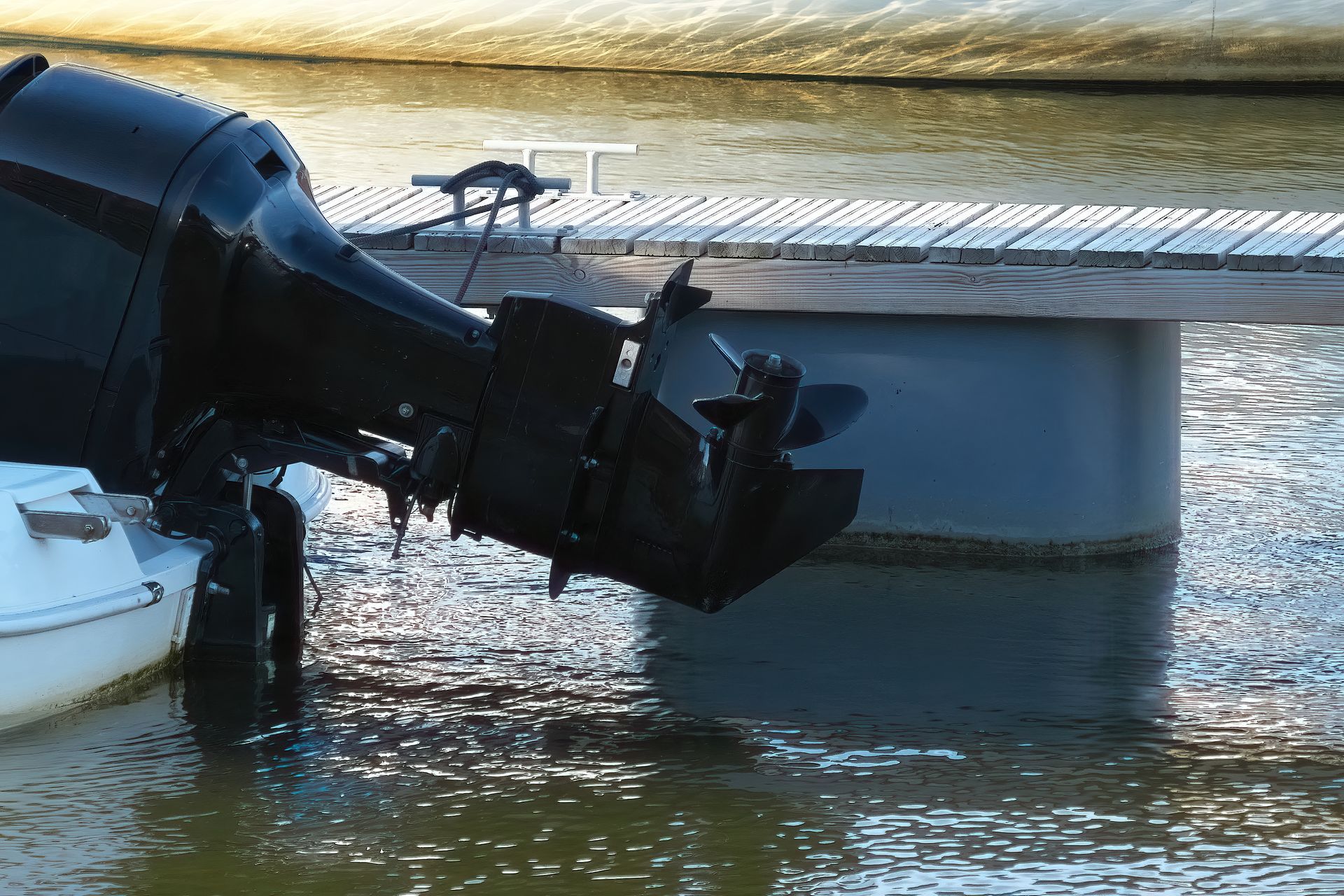 An outboard motor is attached to a boat in the water