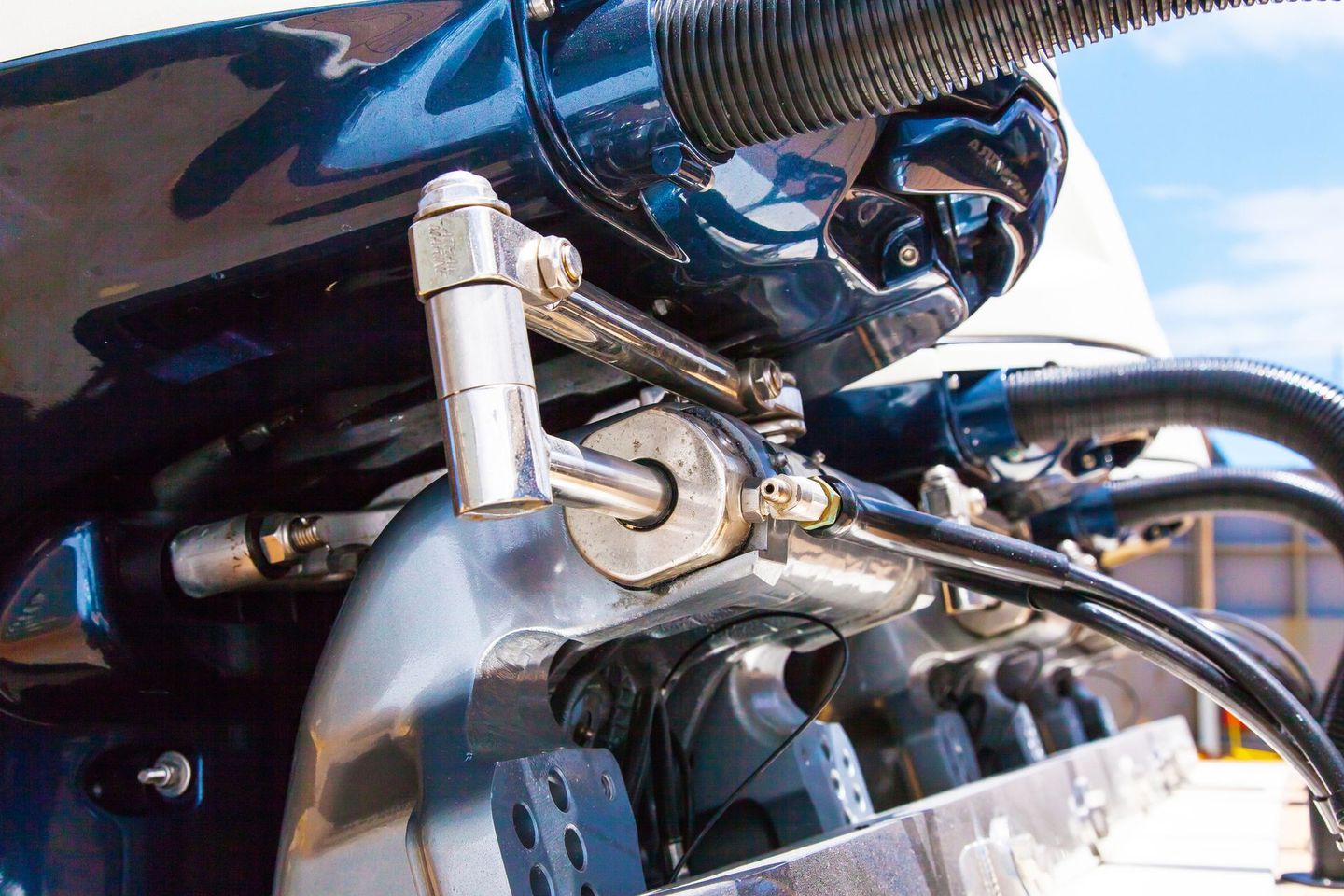 A close up of a motorcycle engine with a hose attached to it
