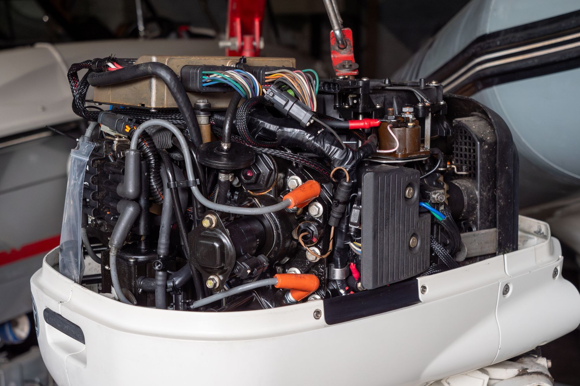 The engine of a boat is being repaired in a garage.