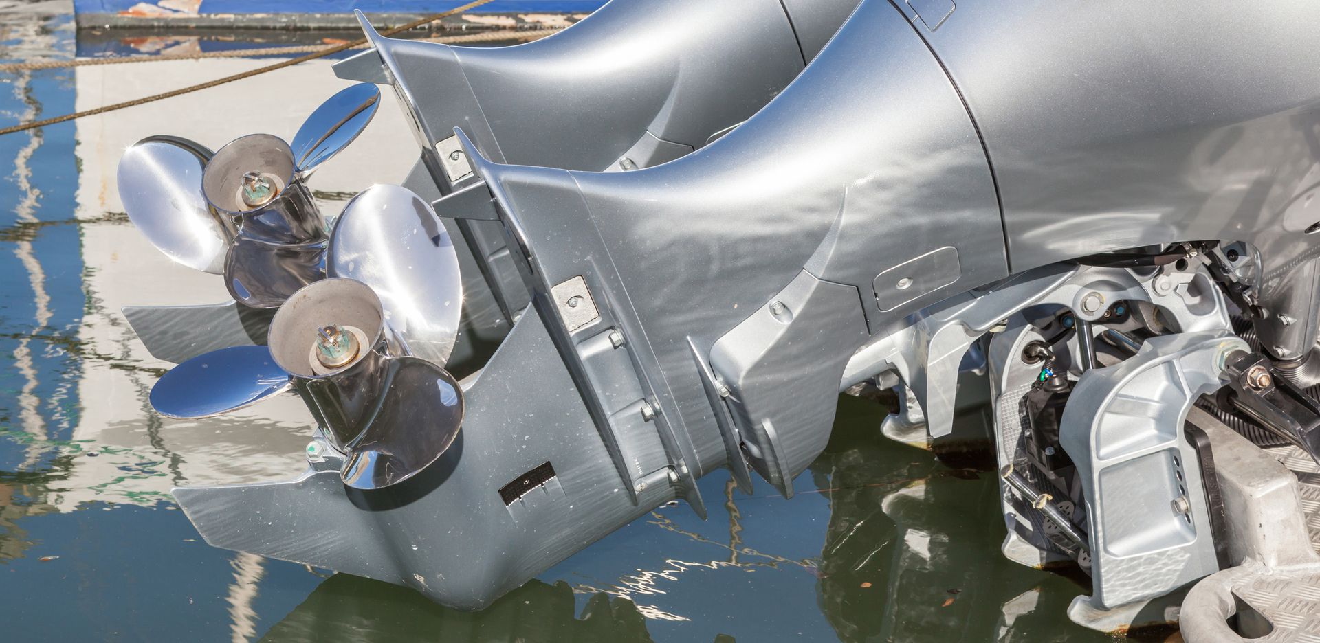 The engine of a boat is sitting in the water.