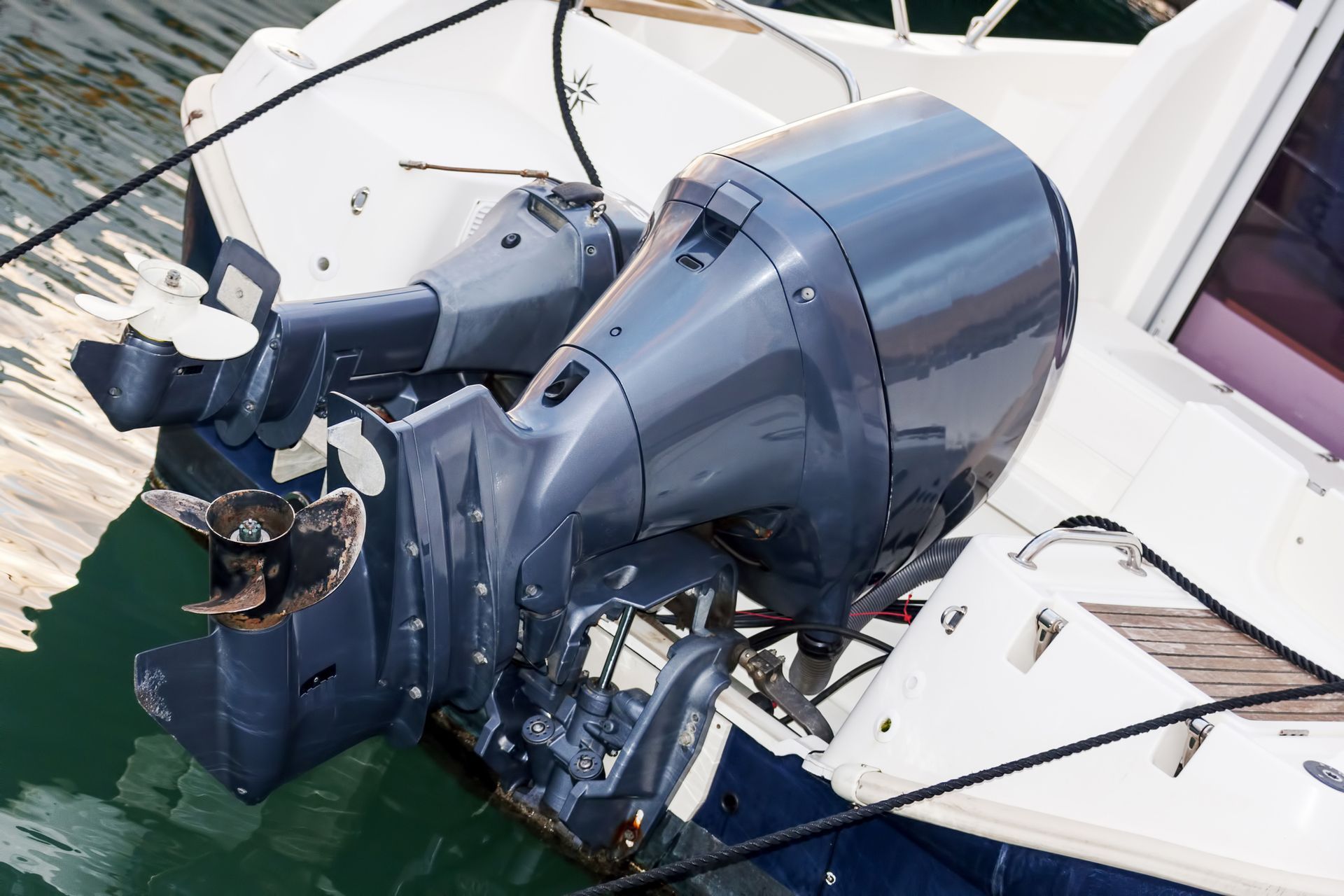 A blue outboard motor is attached to the side of a boat.