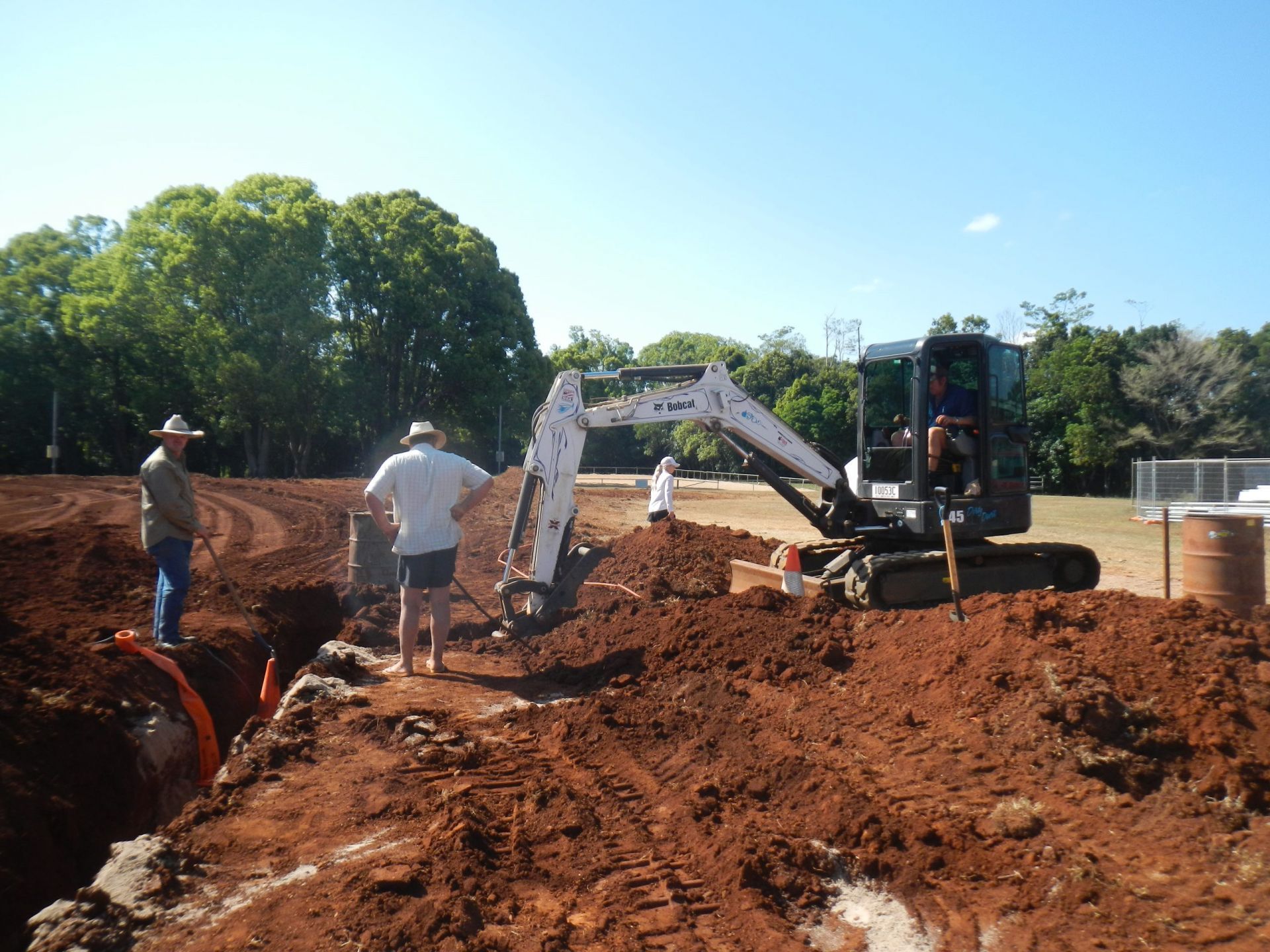Workers Operate Excavators at a Muddy Construction Site — Evans Earthmoving Contractors In Mareeba, QLD