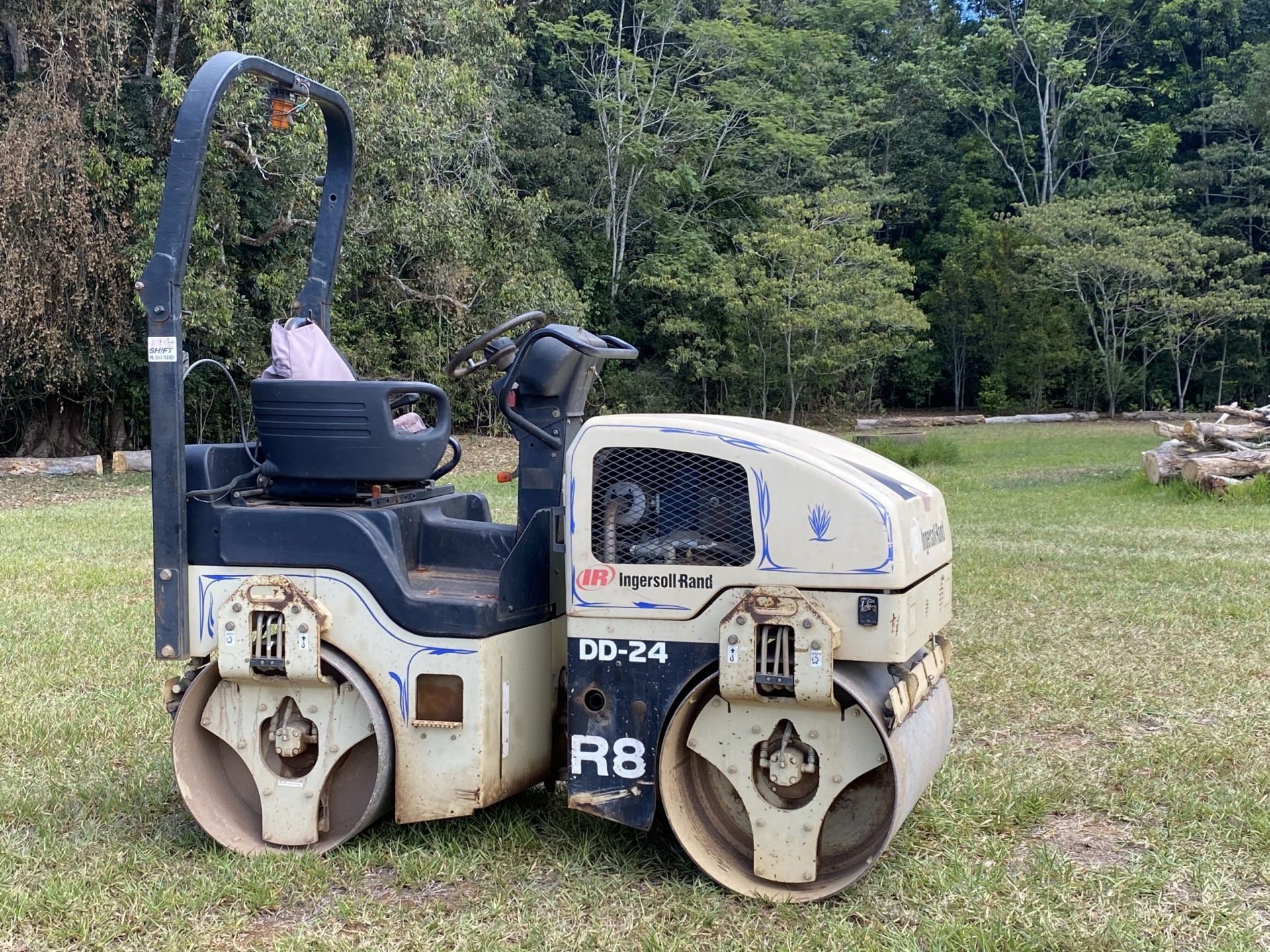 A Vibratory Roller Compactor, Model Dd-24 R8, Parked on Grass — Evans Earthmoving Contractors In Malanda, QLD 