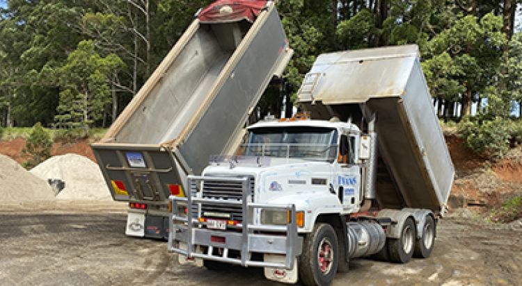 Dump Truck with Raised Bed, Unloading Gravel, Outdoors — Evans Earthmoving Contractors In Malanda, QLD
