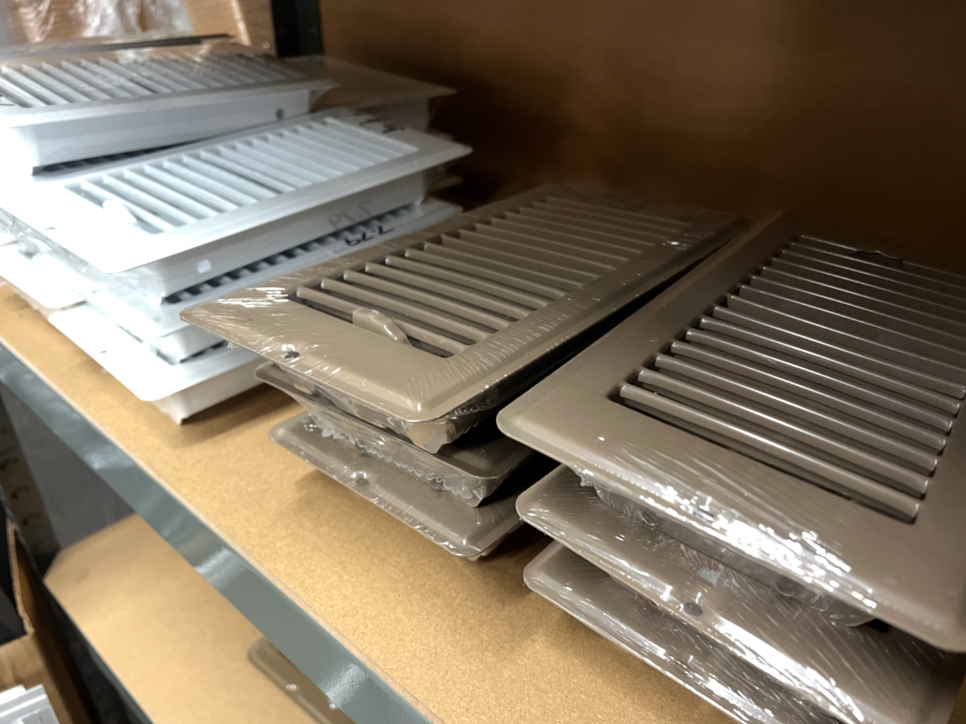 A shelf with a bunch of air vents stacked on top of each other