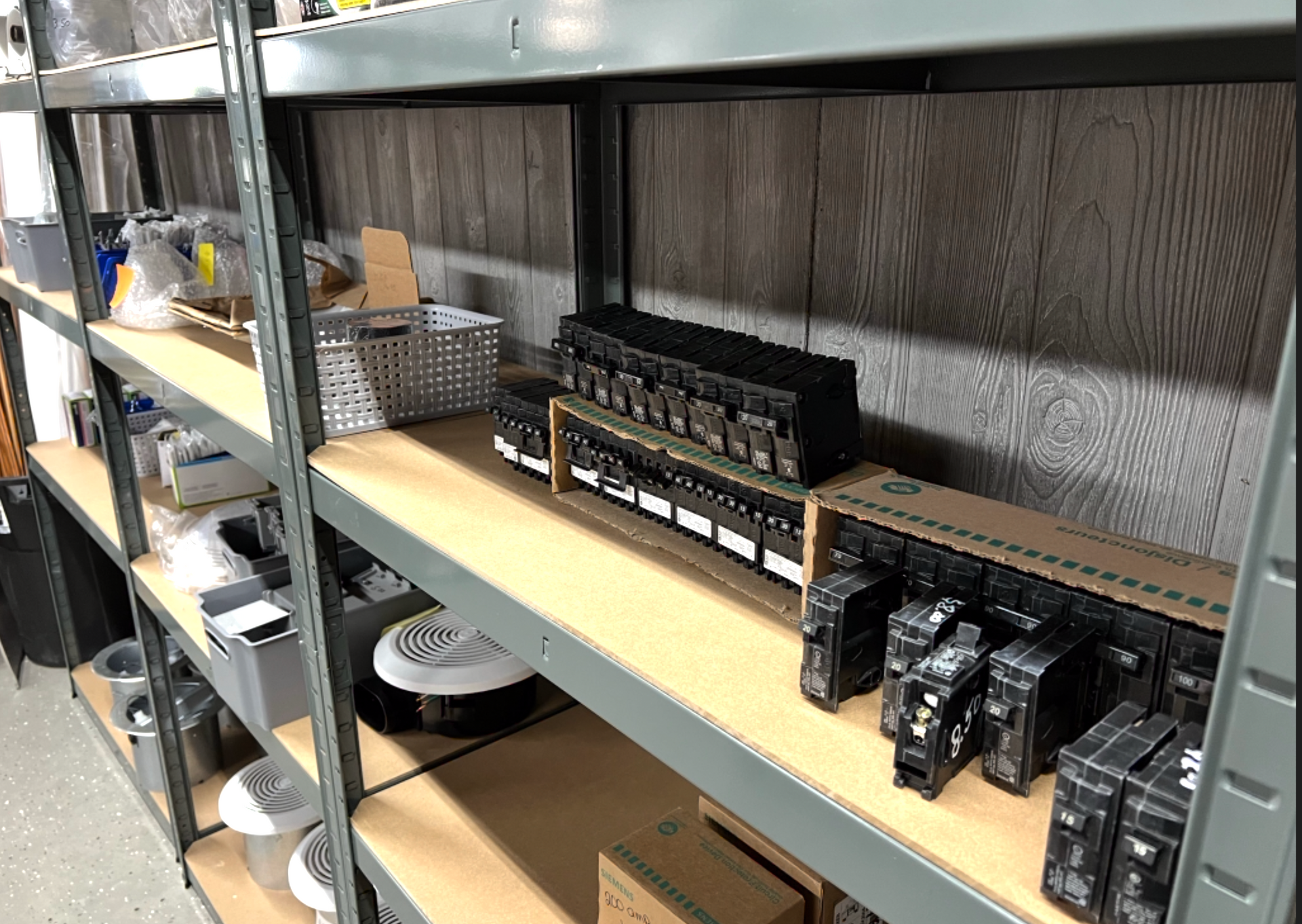 A warehouse filled with shelves filled with lots of electrical equipment.