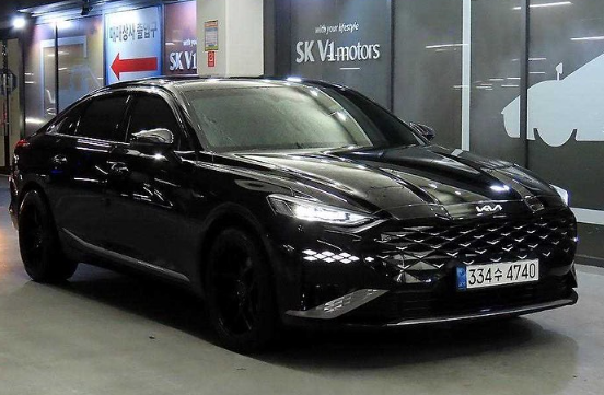 A black car is parked in a parking garage.