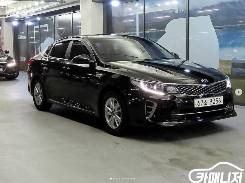 A black car is parked in a parking garage.