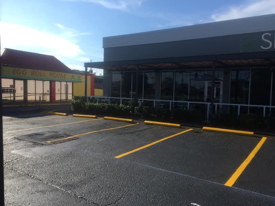 freshly paved and striped asphalt parking lot