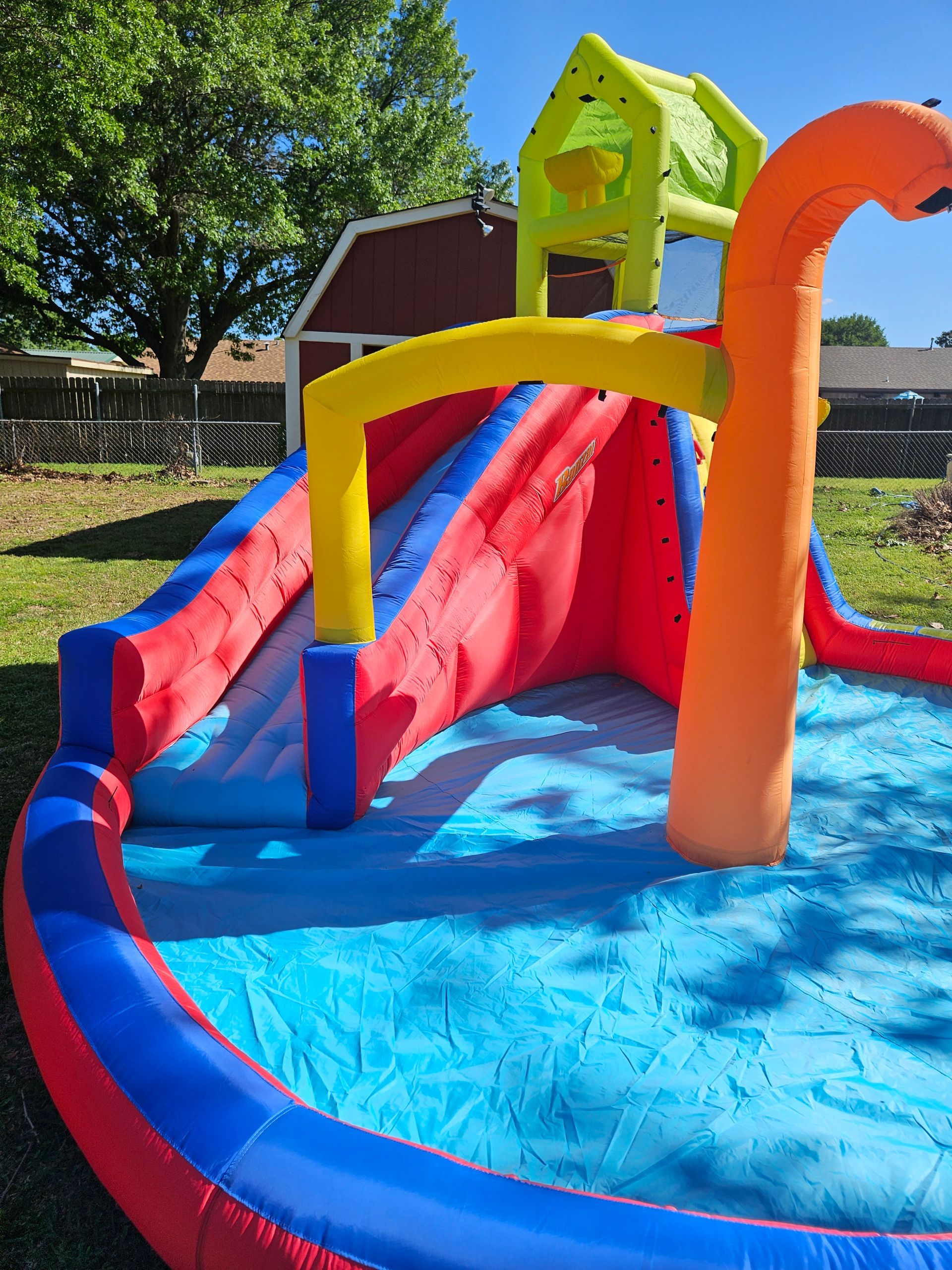 An inflatable water slide with a house on top of it