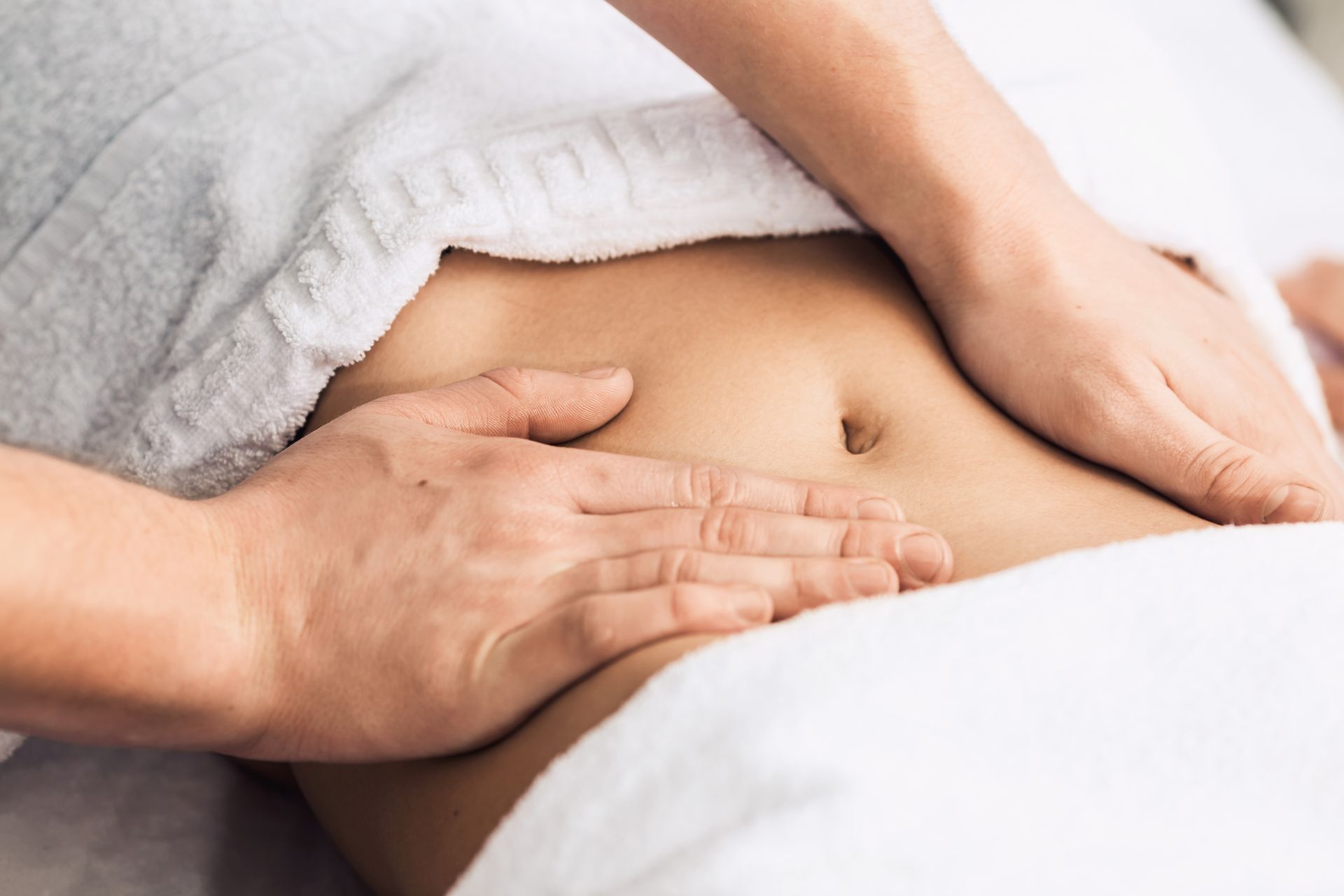 A woman is getting a massage on her stomach at a spa.