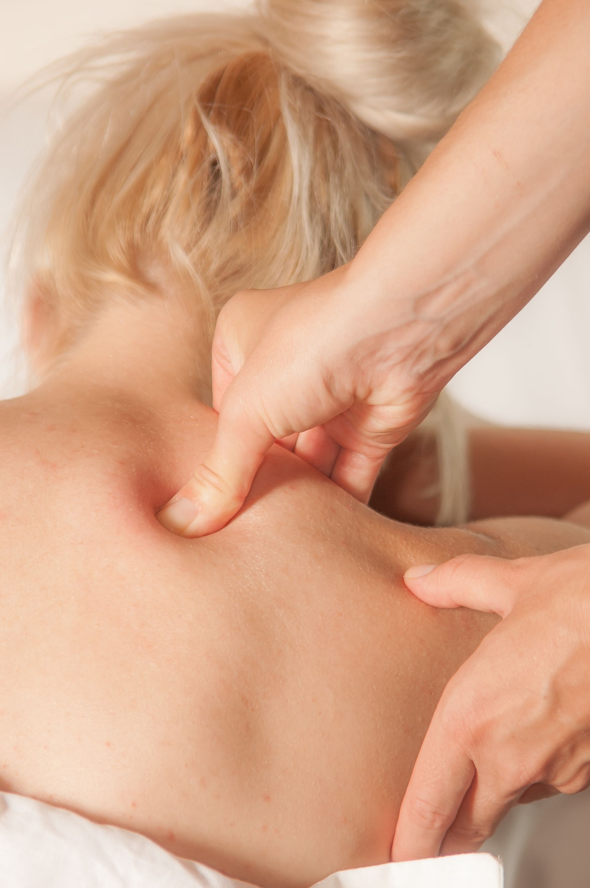 A woman is getting a massage on her back.