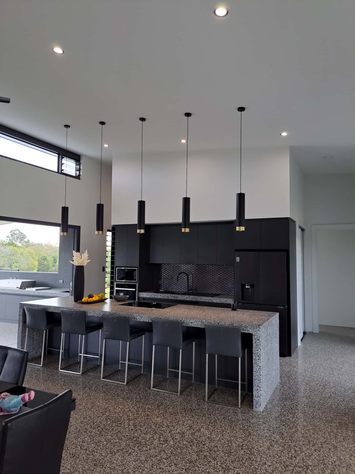 Modern Kitchen With Black Cabinets, Island, and Bar Stools — AB QUICK Painting & Maintenance Services In Mareeba, QLD