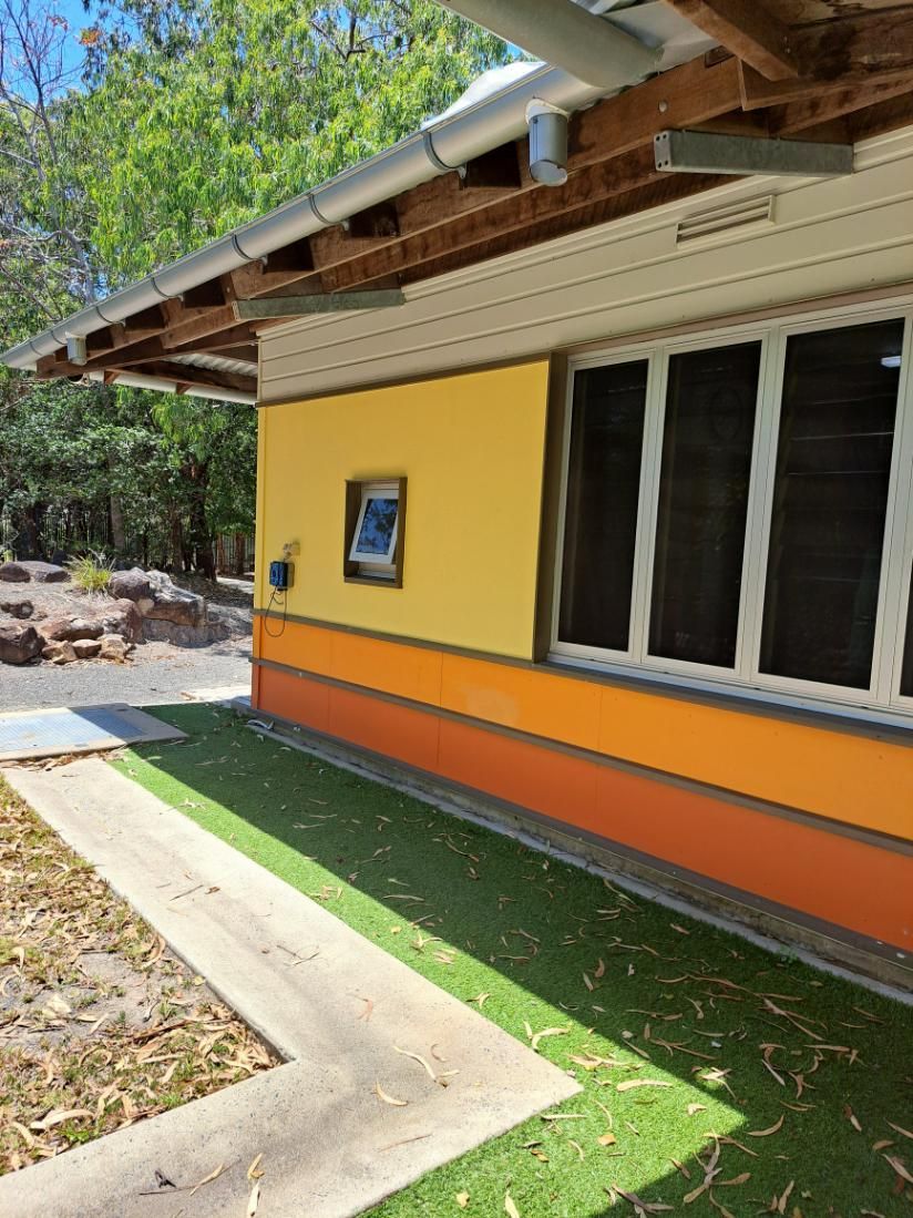 Building With Yellow, Orange, and White Walls, and Windows — AB QUICK Painting & Maintenance Services In Mareeba, QLD